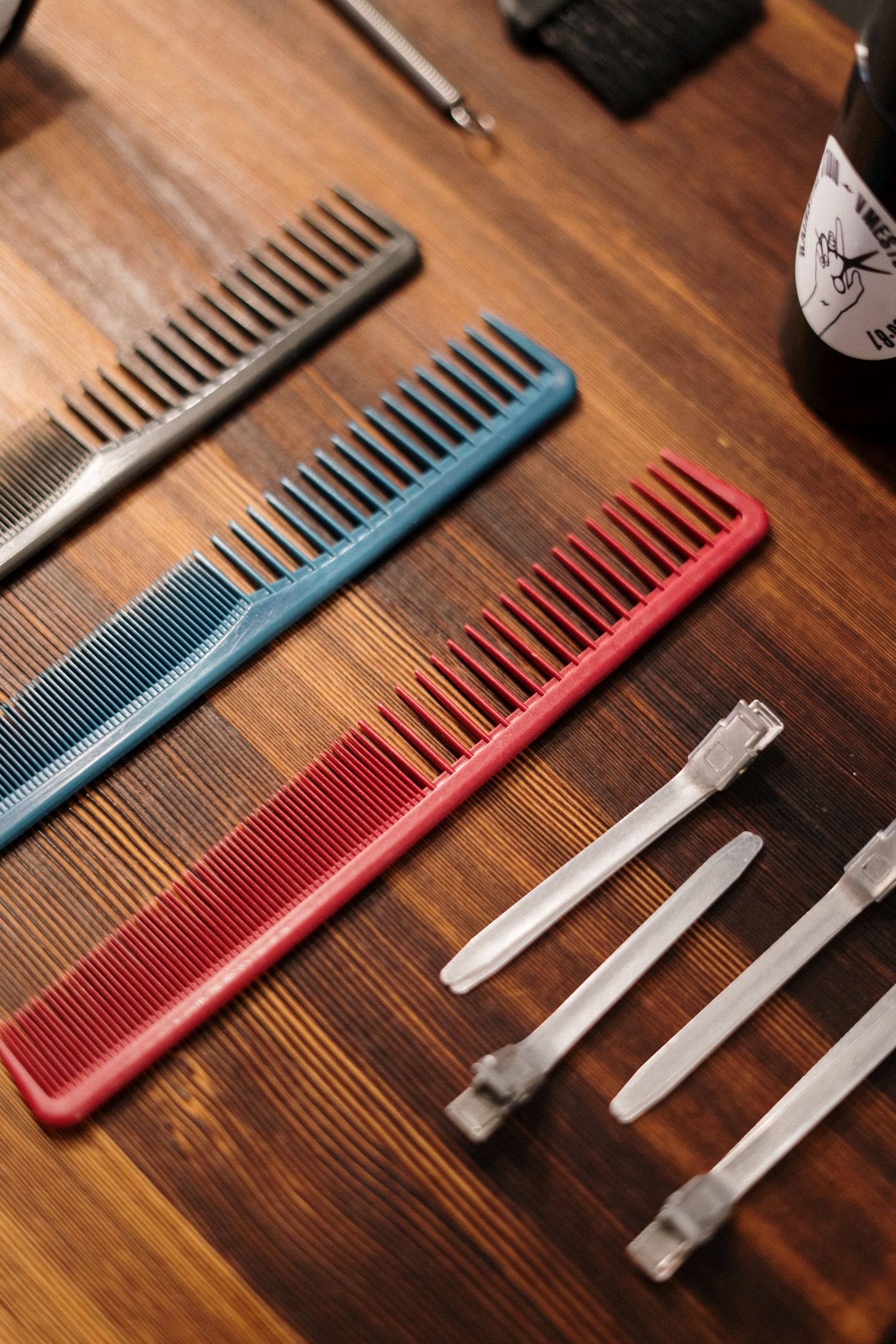 Several differently colored combs on a barber worktop