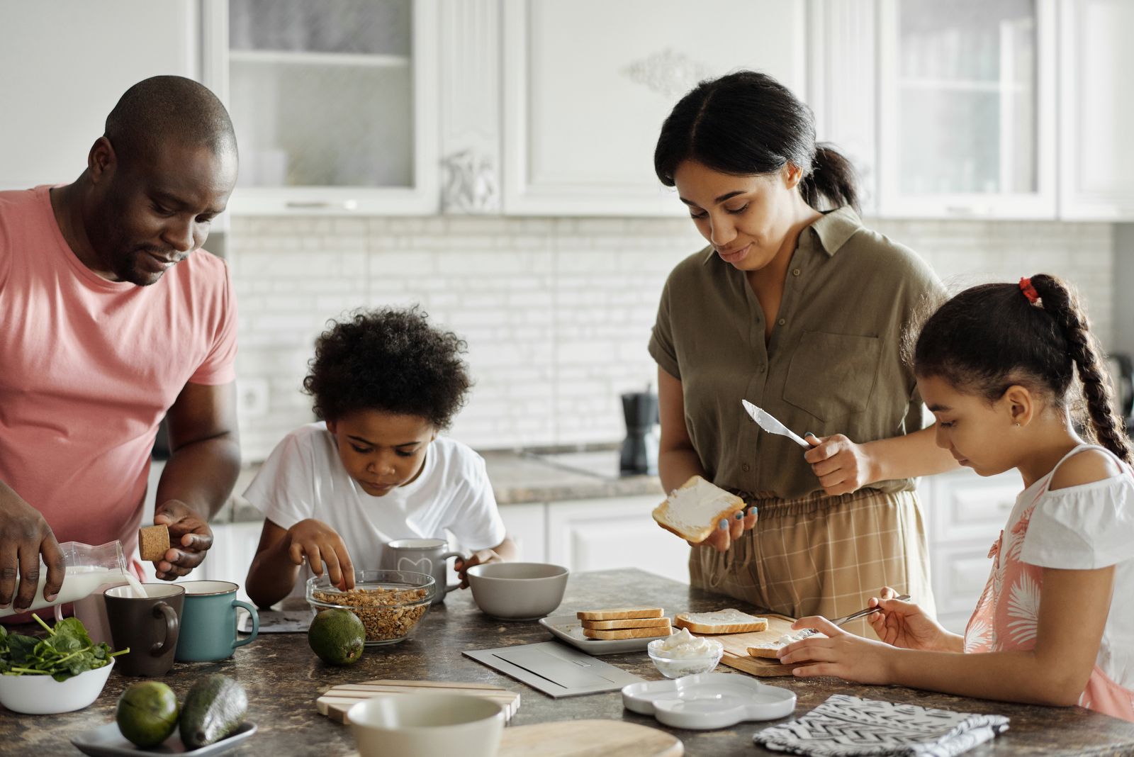 A family preparing food together at a kitchen counter