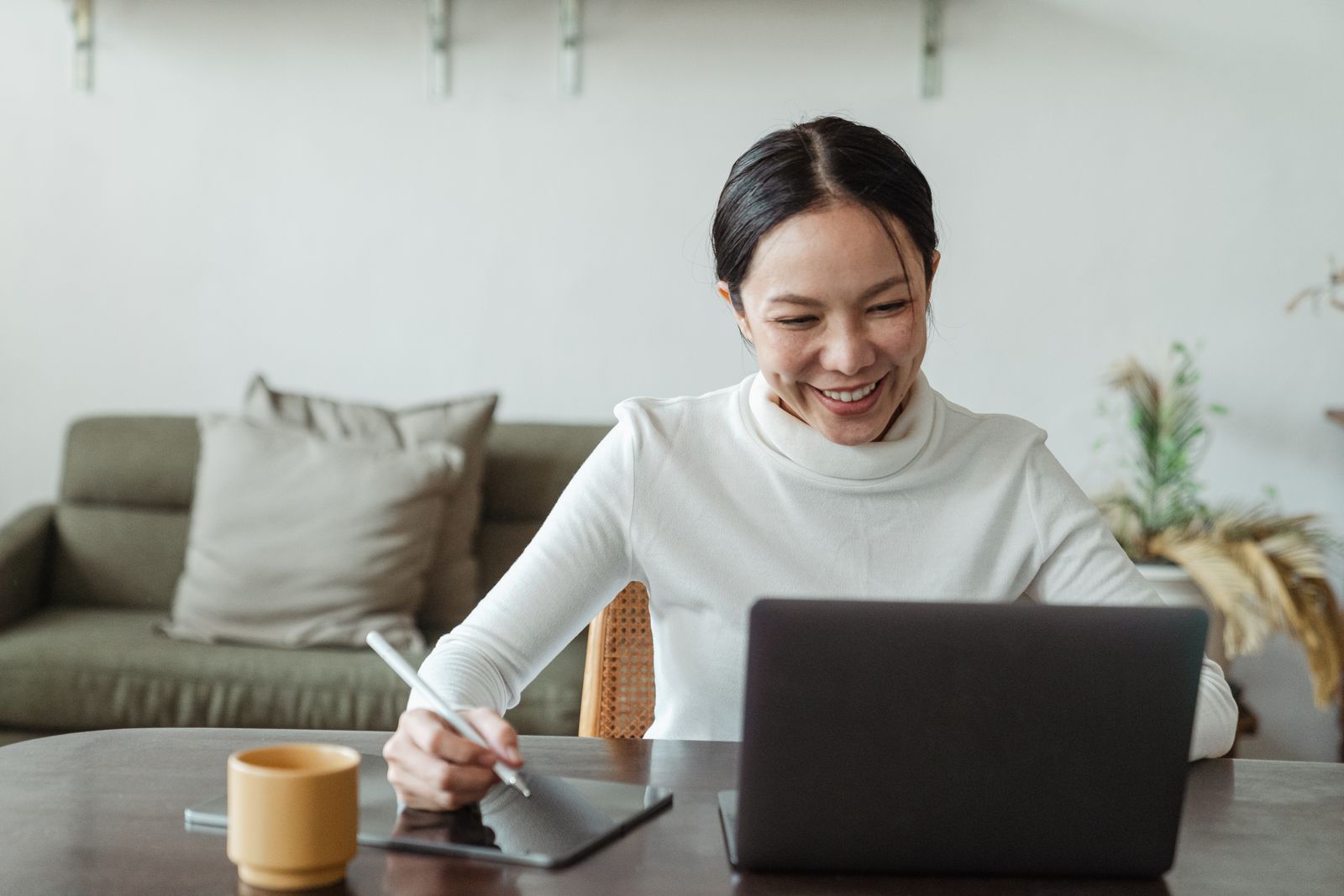 A person using a laptop at a living-room table