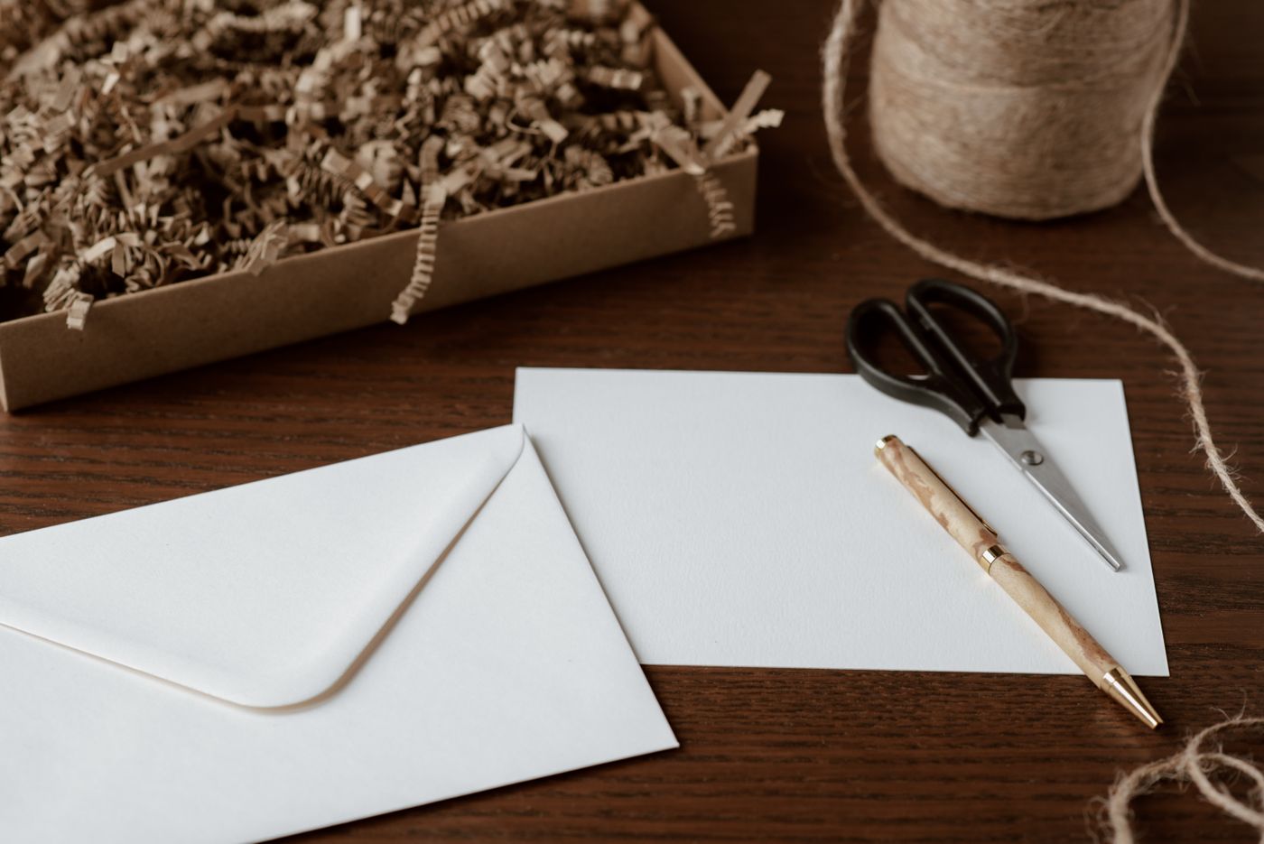 Blank envelope and writing supplies arranged on a work surface