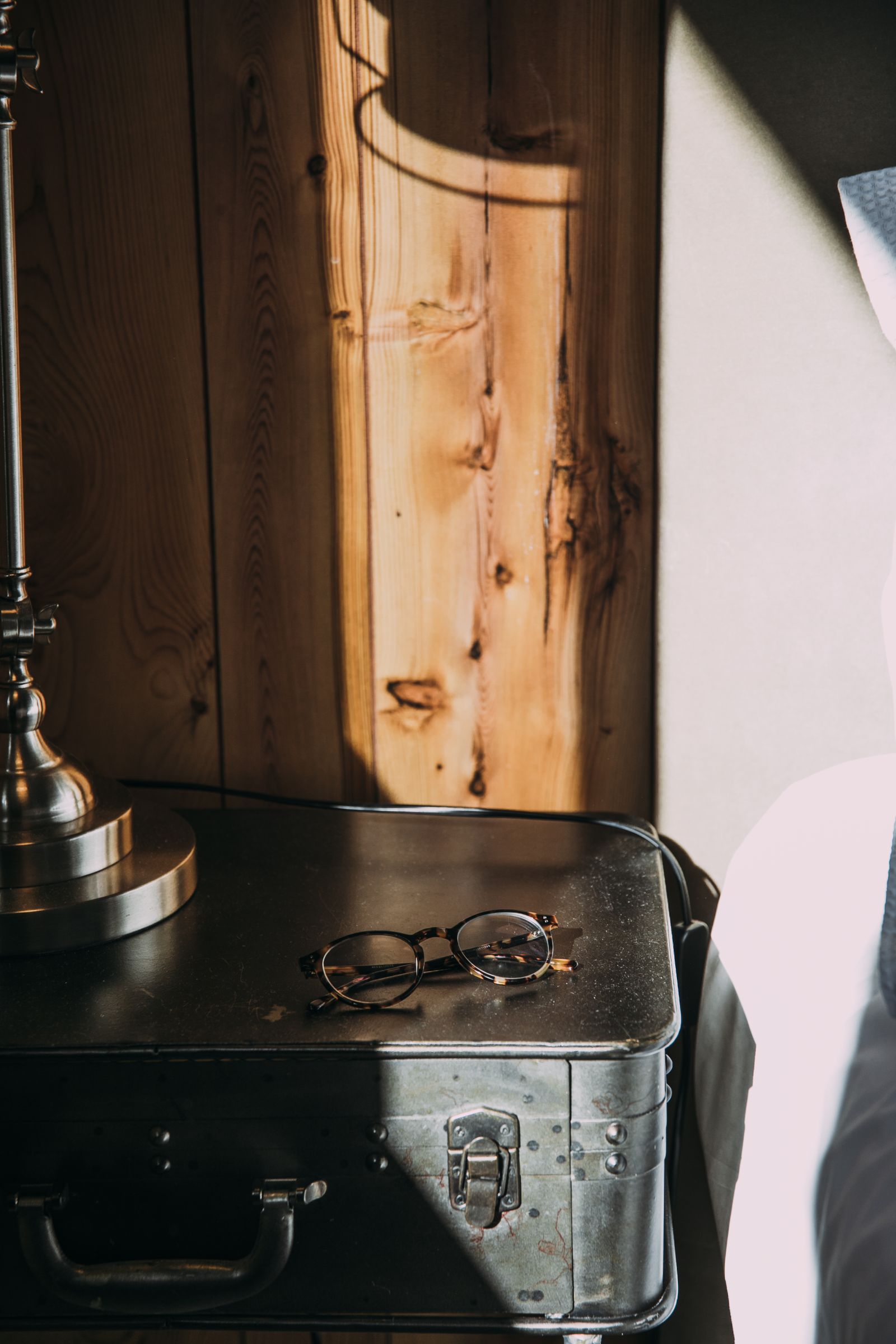 Glasses resting on a small metal bedside cabinet