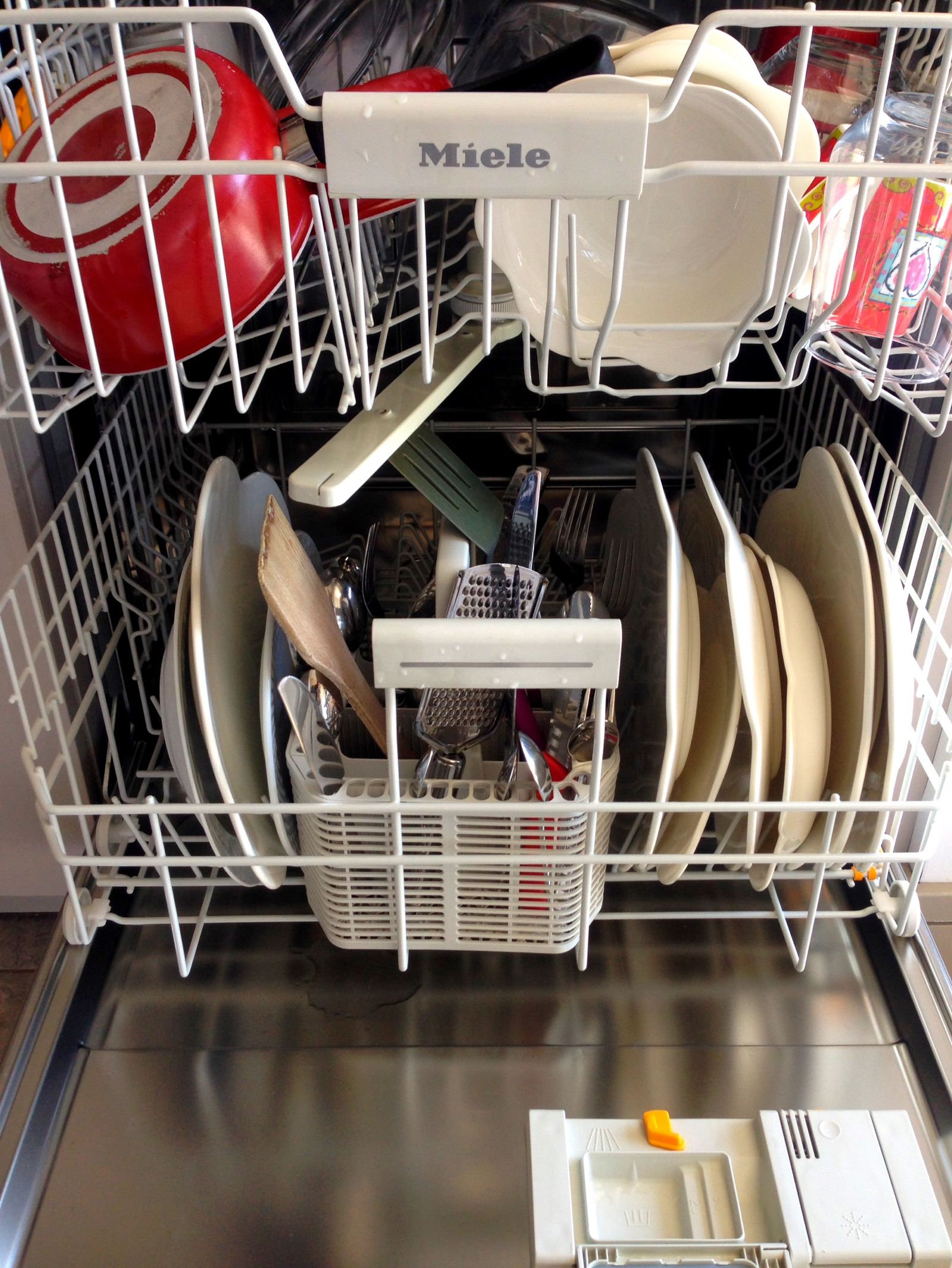 Dishes arranged inside an open dishwasher