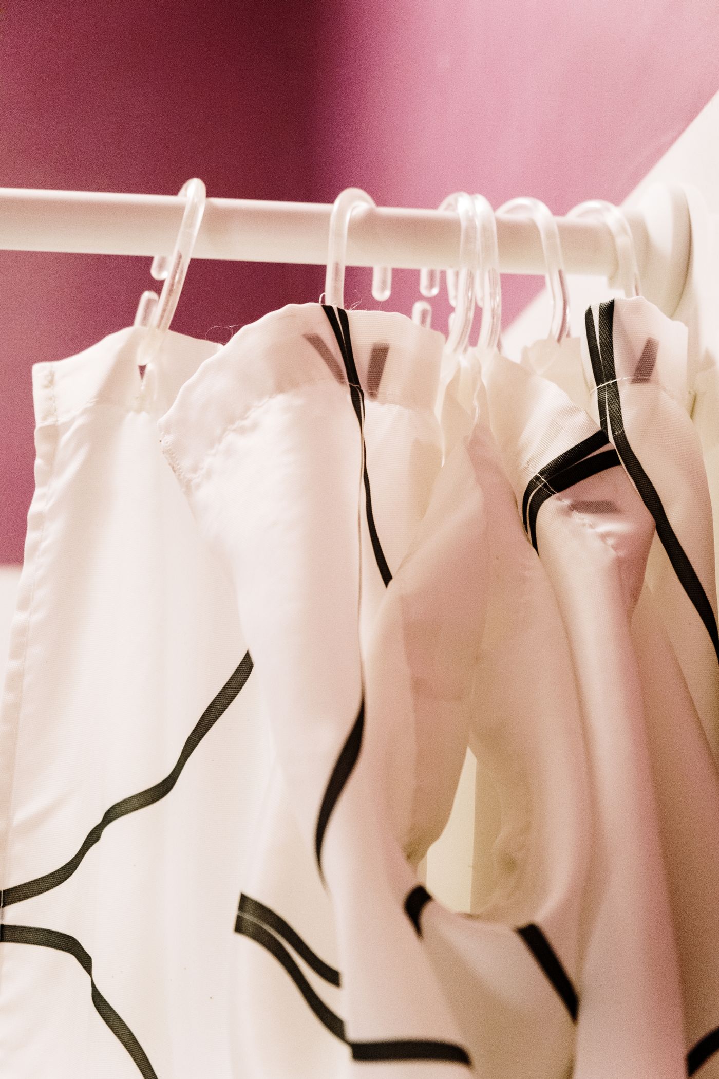 Shower-curtain rings and hanging fabric in close-up