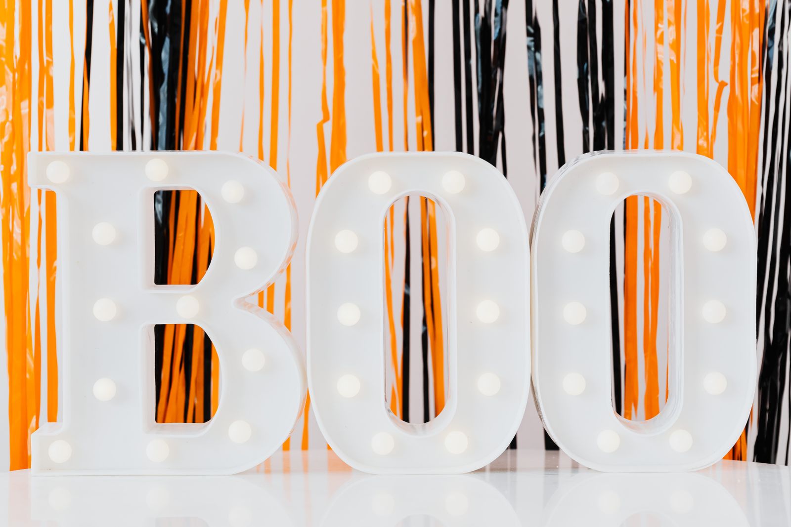 Illuminated BOO decoration in a Halloween display