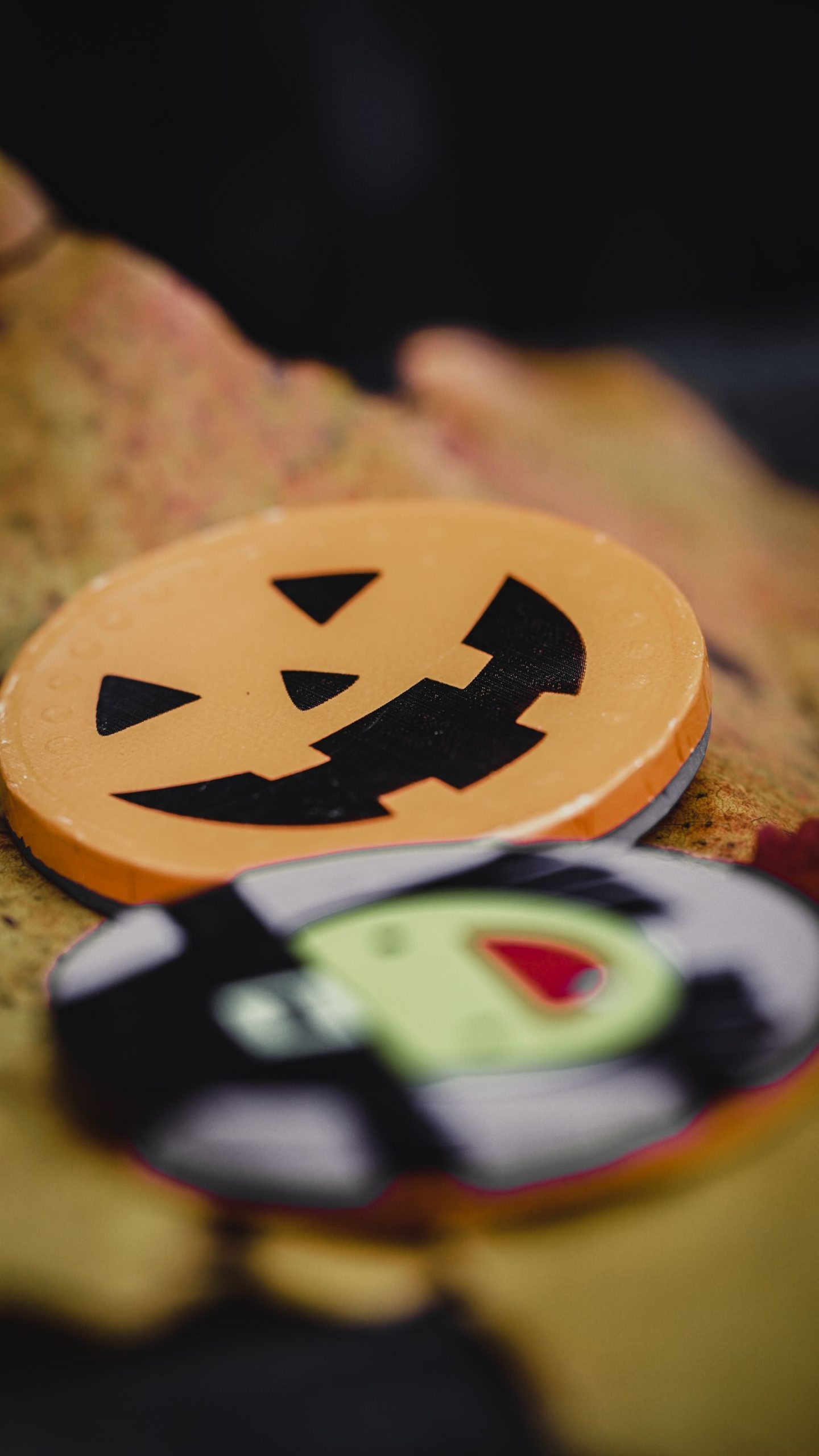 A jack-o-lantern beside Halloween decorations