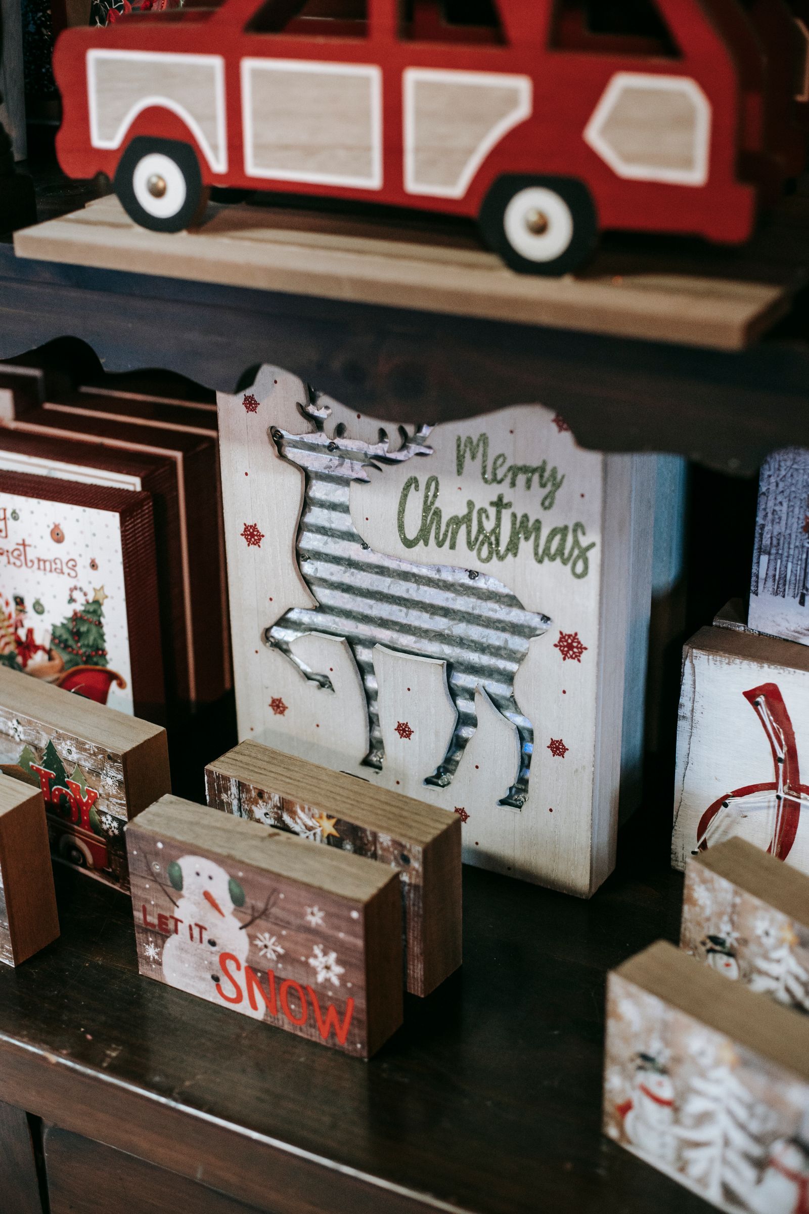 Wooden Christmas decorations on display shelves