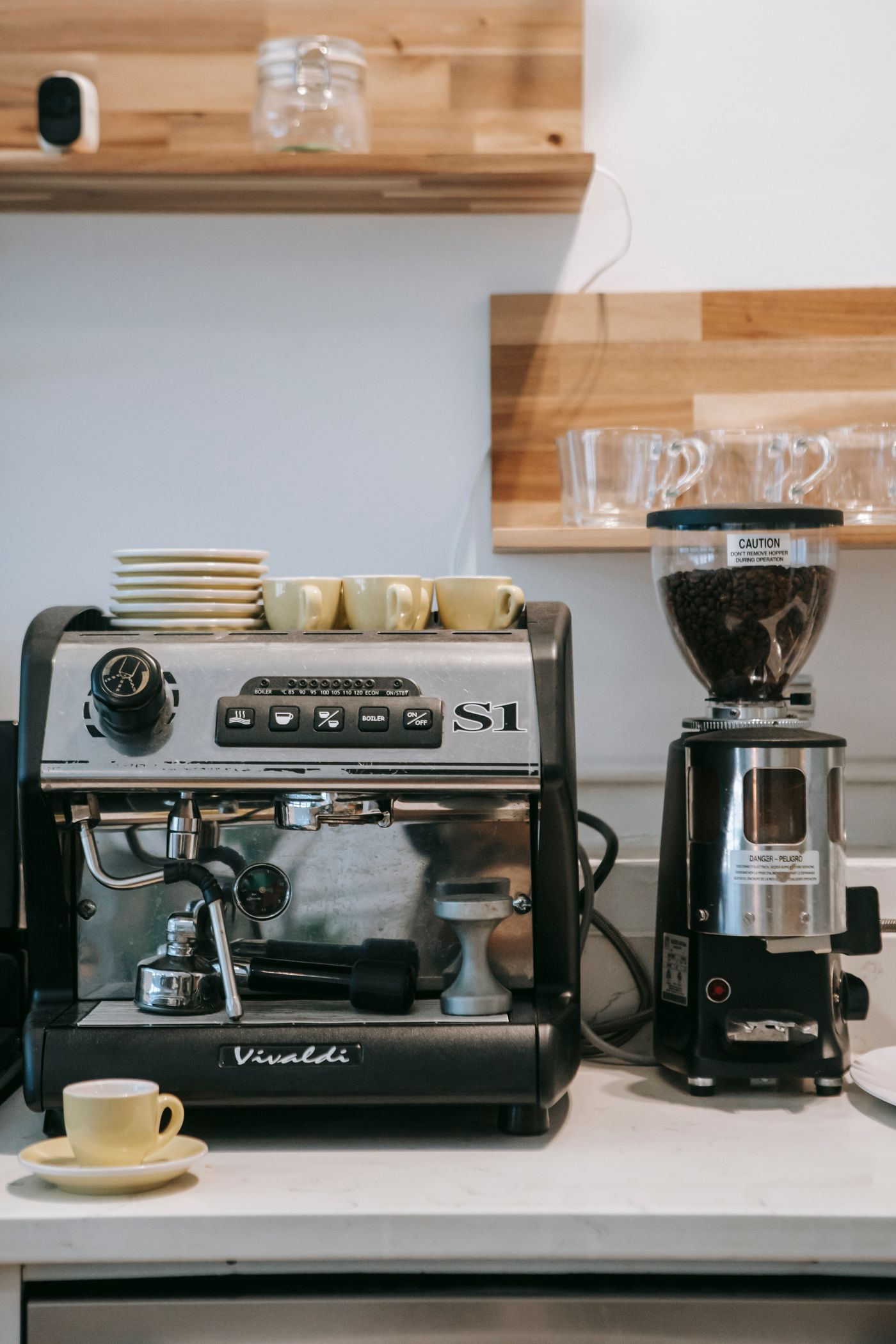 An espresso machine and grinder in a working counter area