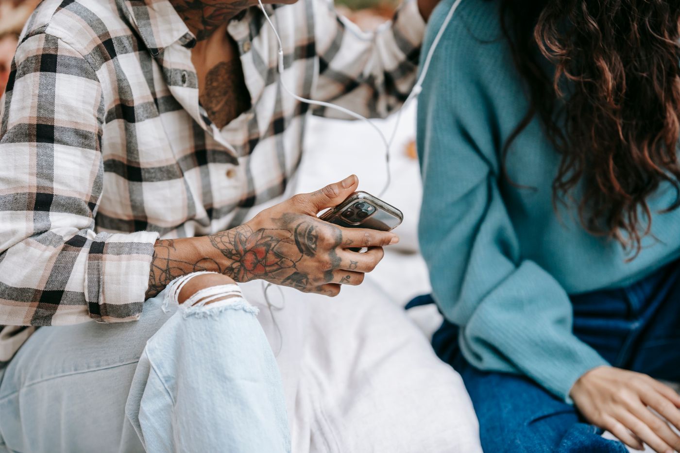 Friends looking at a phone together while seated