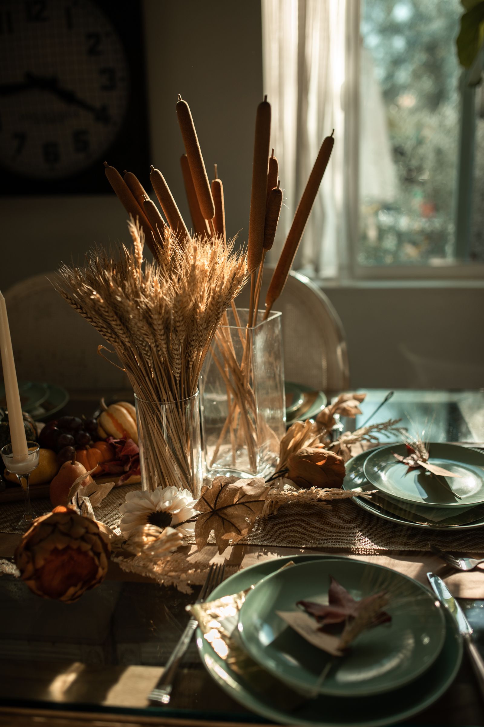 Autumn stems and dishes on a dining table