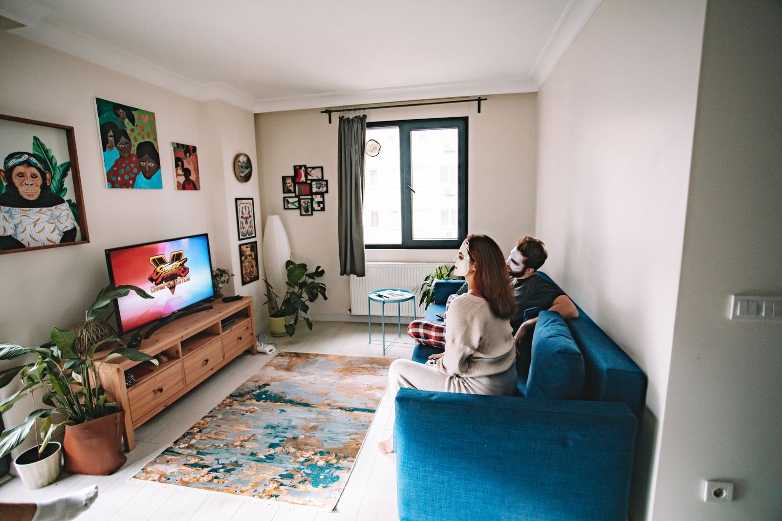 Two adults watching a television in a living room