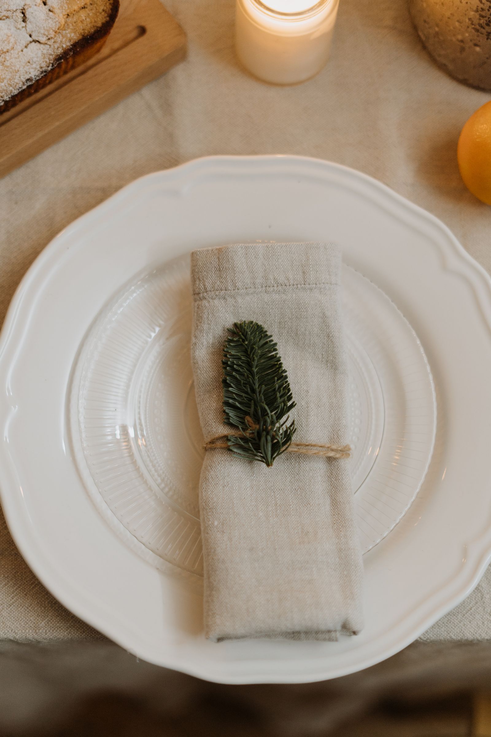 A napkin and greenery on a white plate