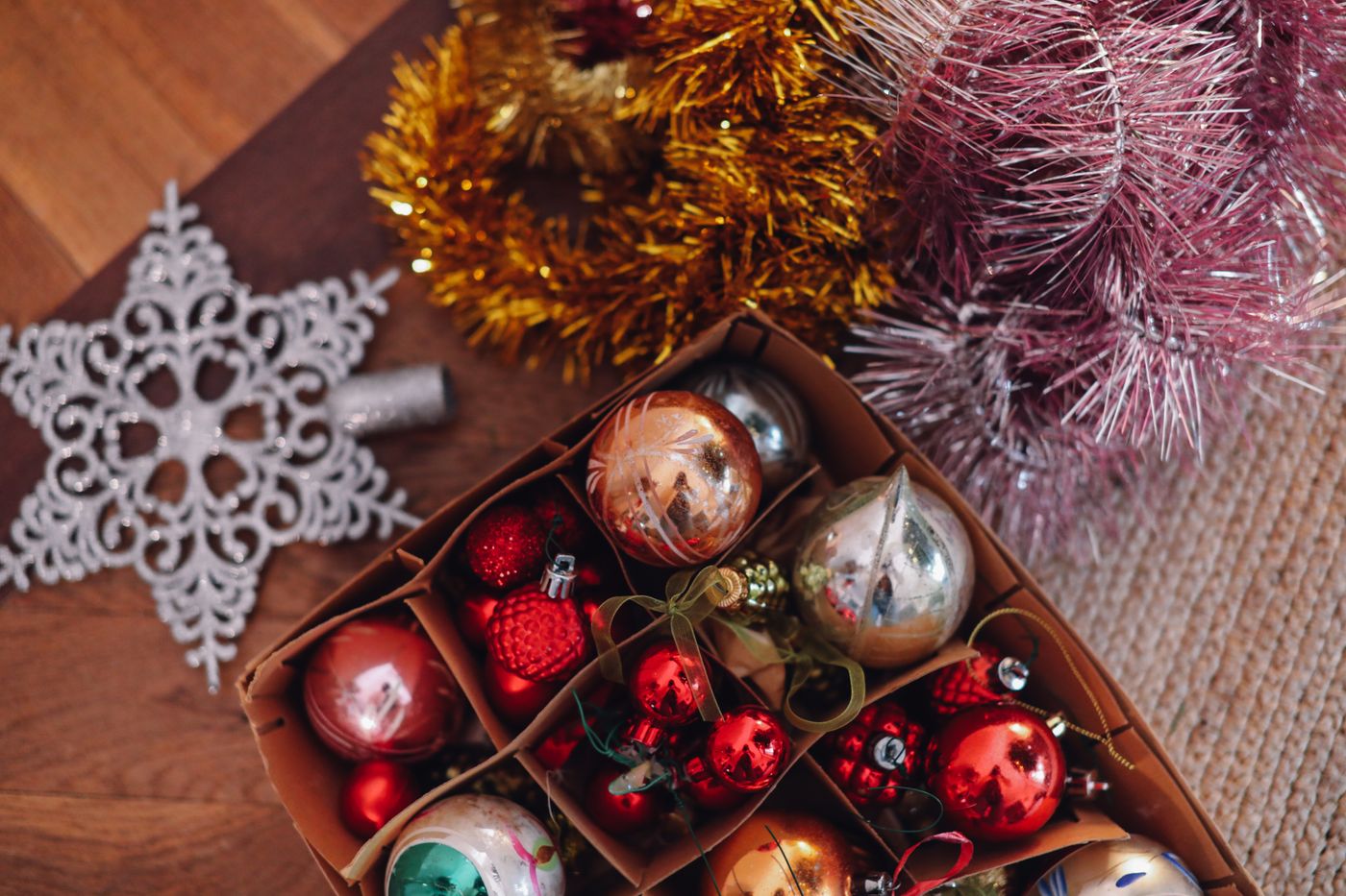 Tinsel and projecting snowflake details beside baubles