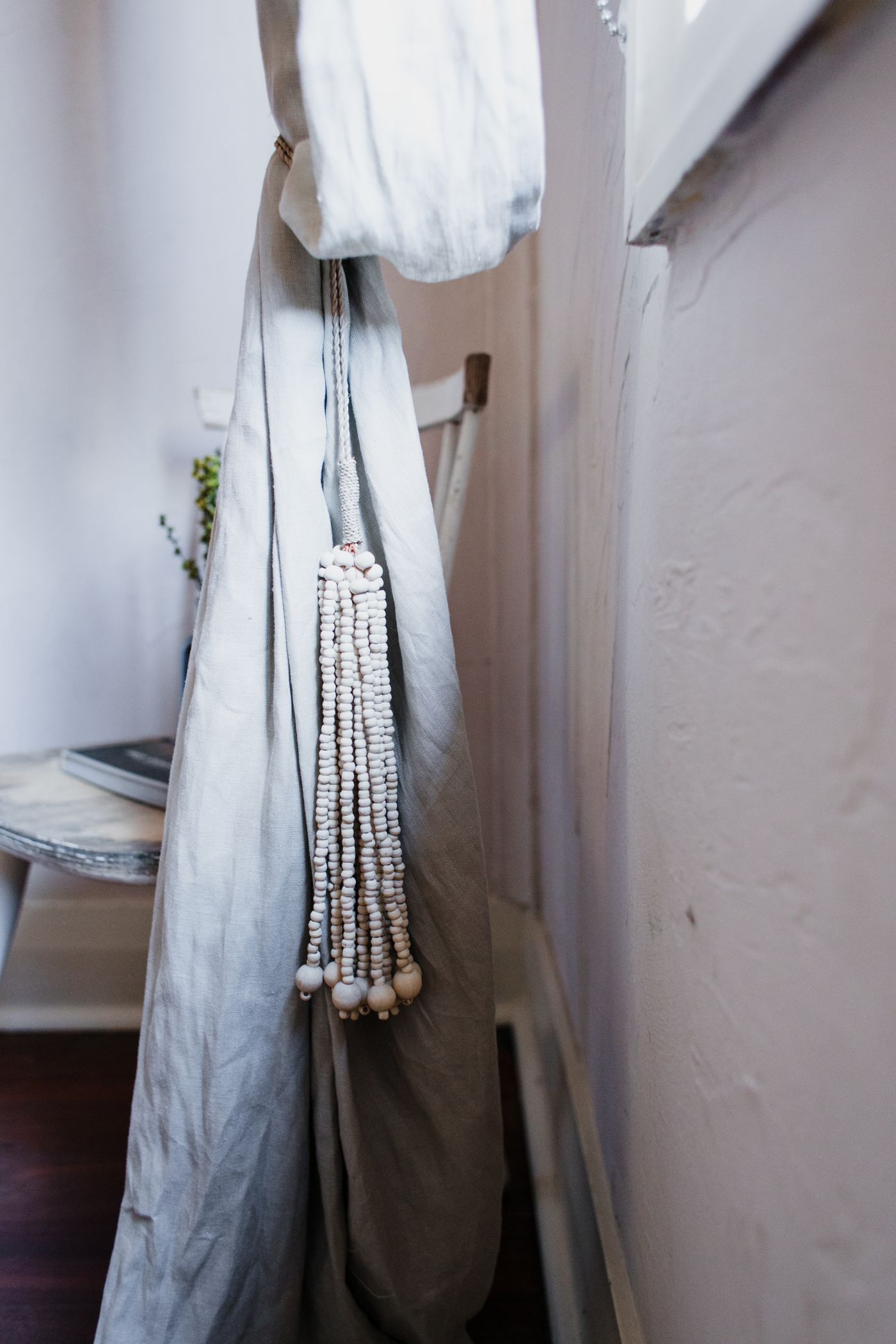 A curtain held aside with a decorative tieback