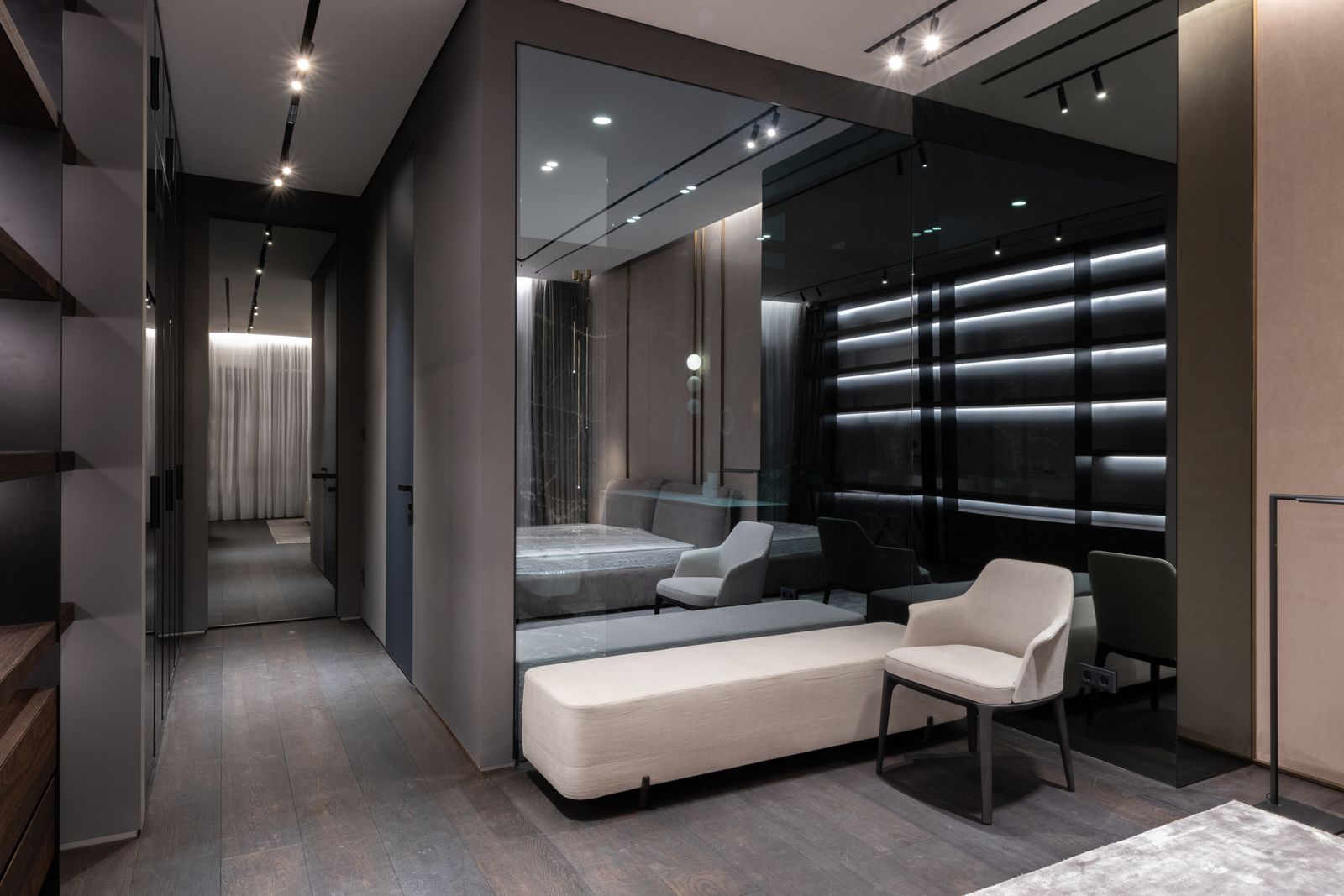 A modern bedroom with large reflective wall panels