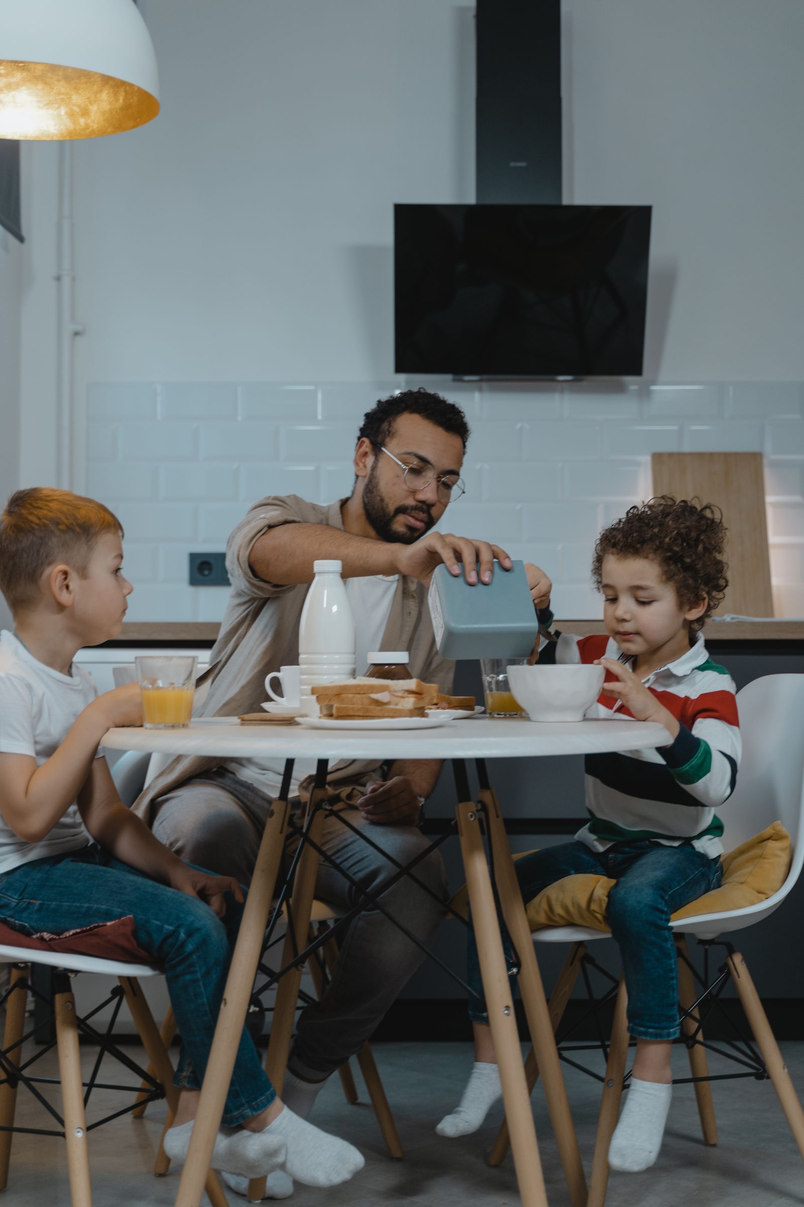 An adult and children eating together at a table