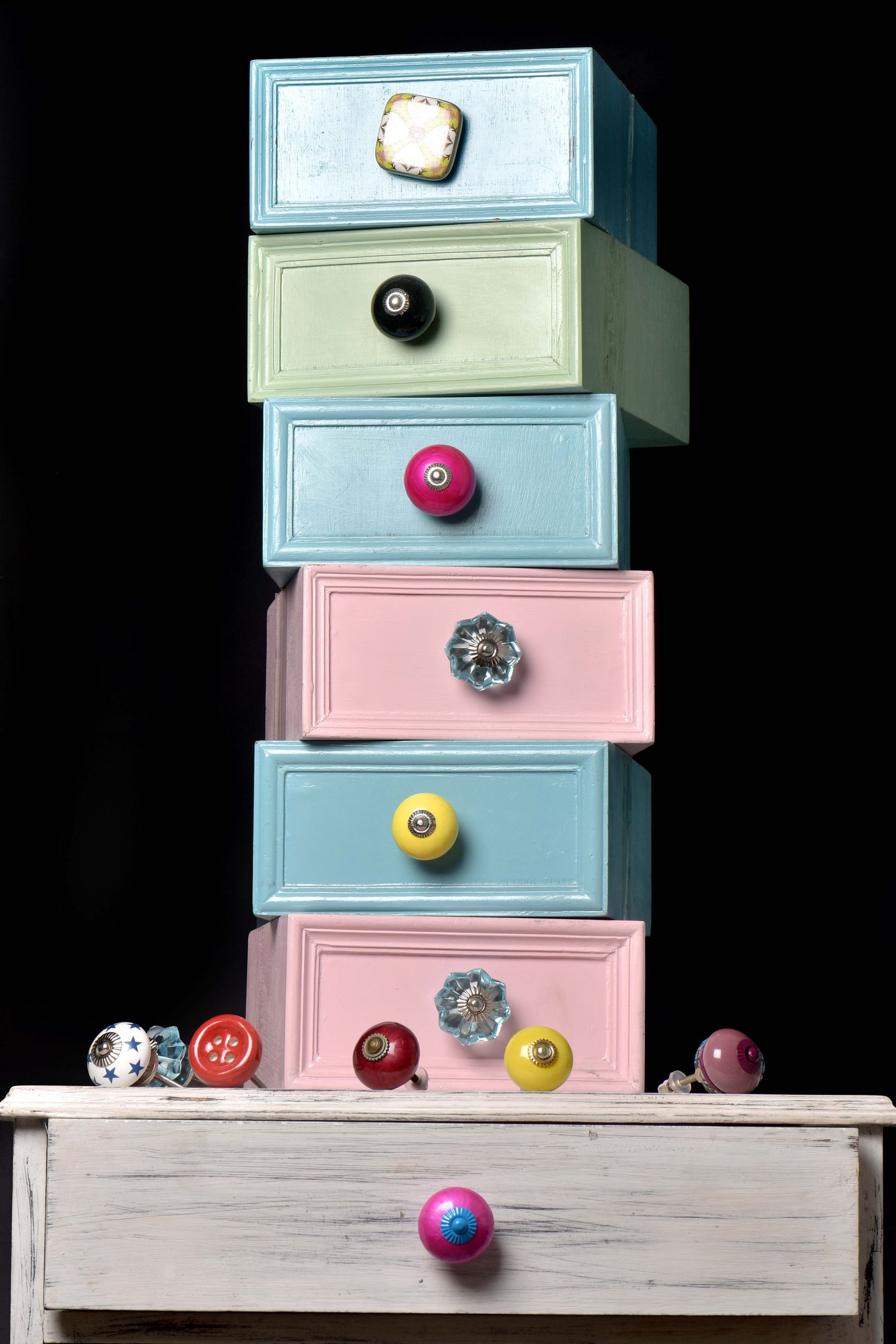 Colorful miniature drawers fitted with varied decorative knobs