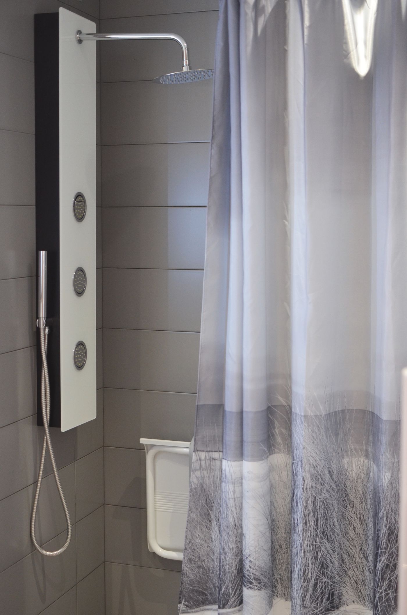 Gray shower curtain across a bathing area