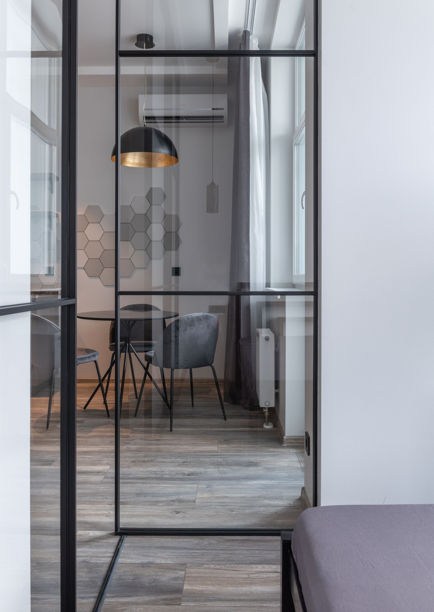 A permanent glass room partition shown as a different format