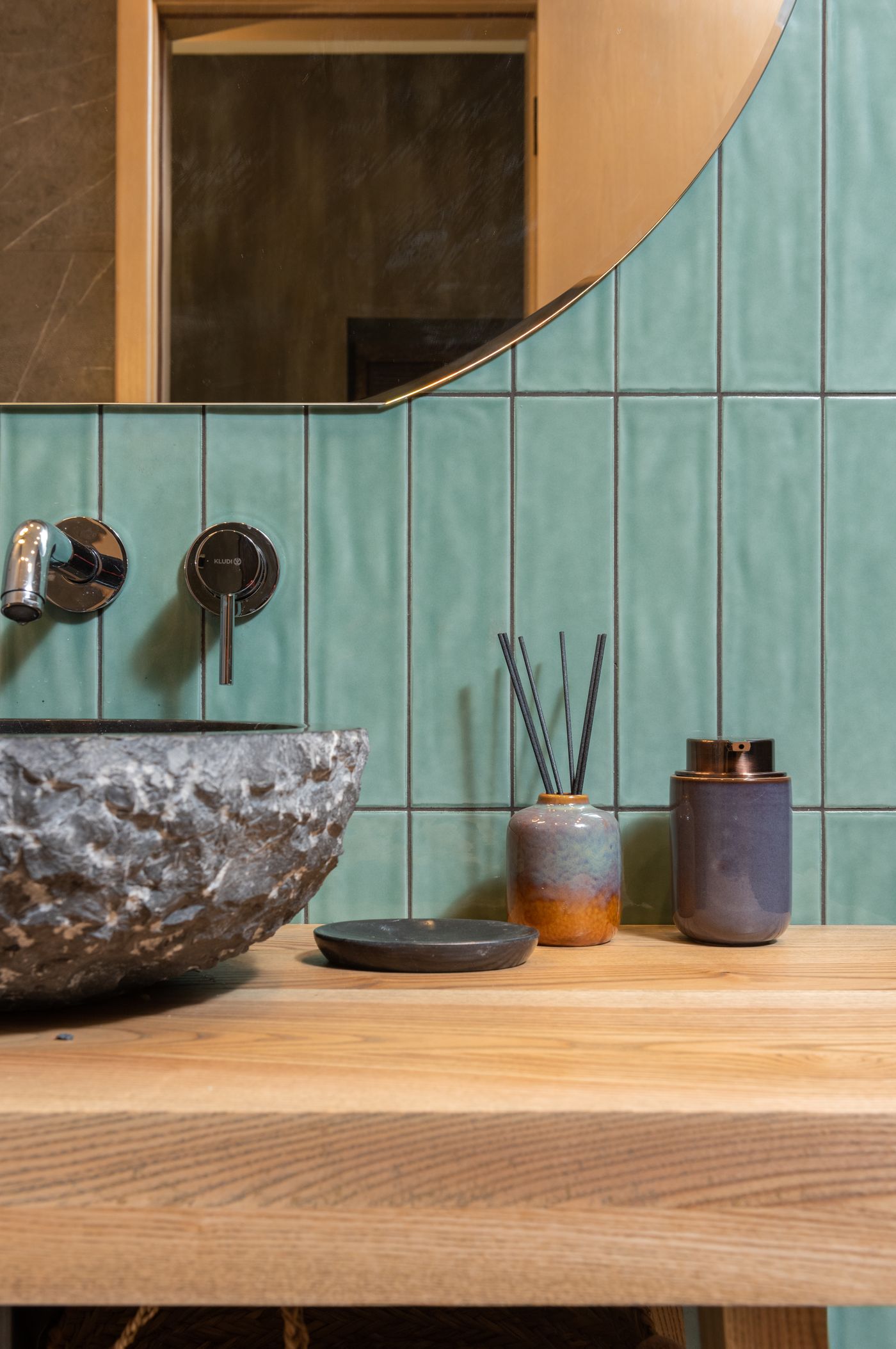 Decorative vessels beside a basin and wall-mounted taps