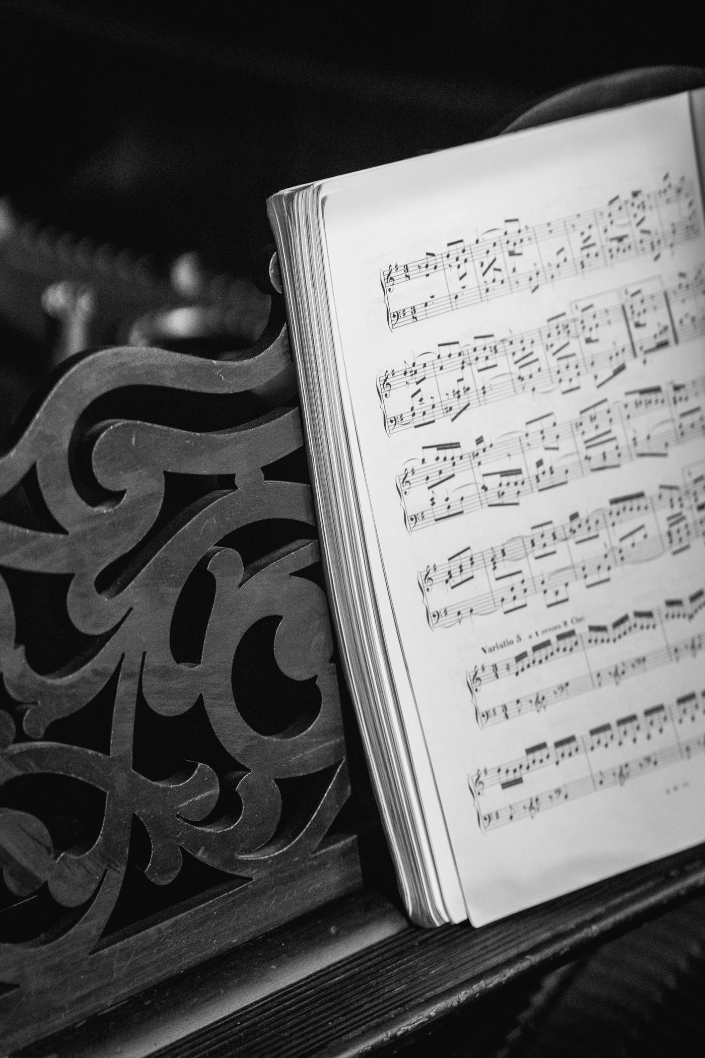 Open music book supported on a decorative rest