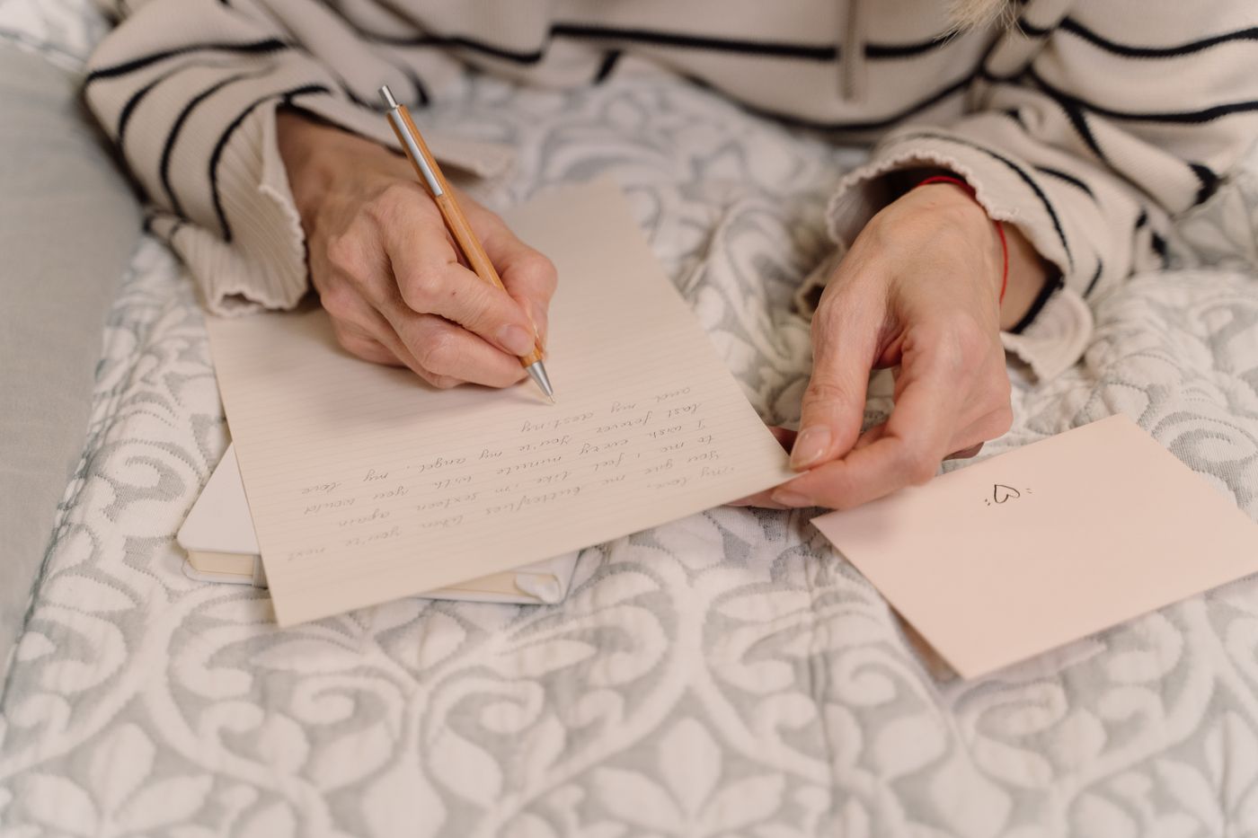 Person handwriting a message on a sheet of paper