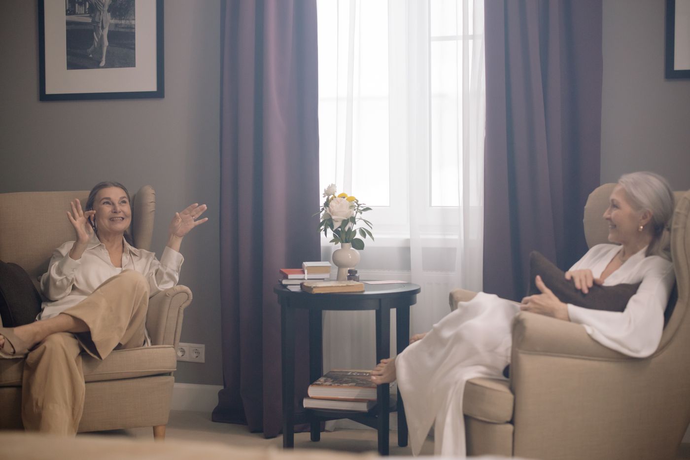Two people seated in armchairs for conversation