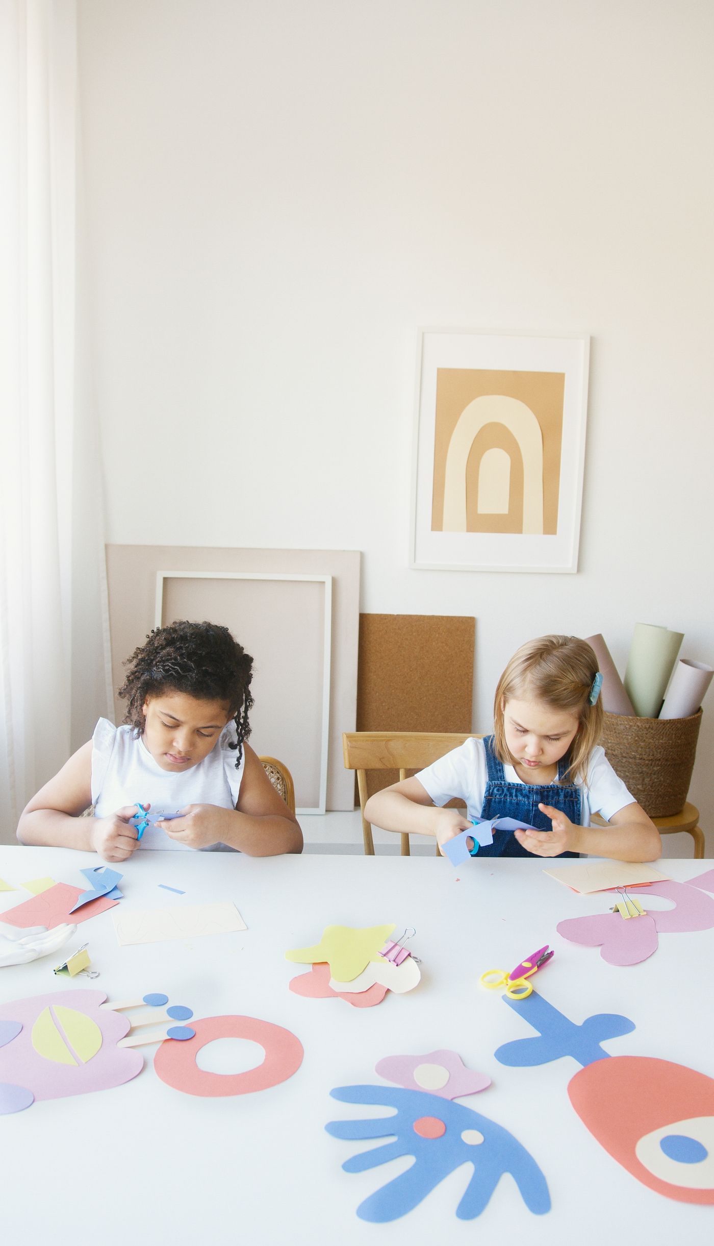 Paper craft materials spread across a shared work table