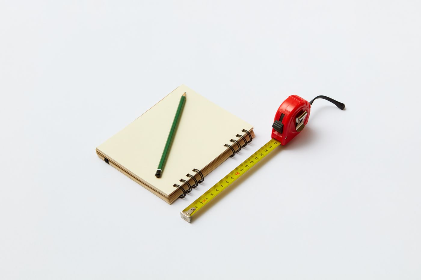 A notebook, pencil, and tape measure for recording dimensions