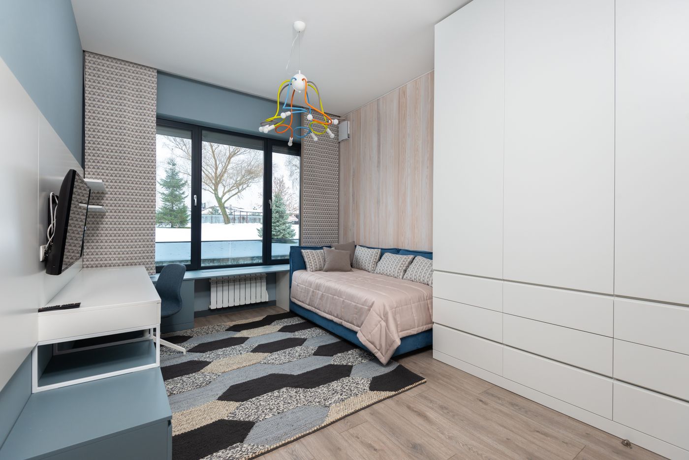 Sofa seating beside a wardrobe in a compact room; footprint-comparison context