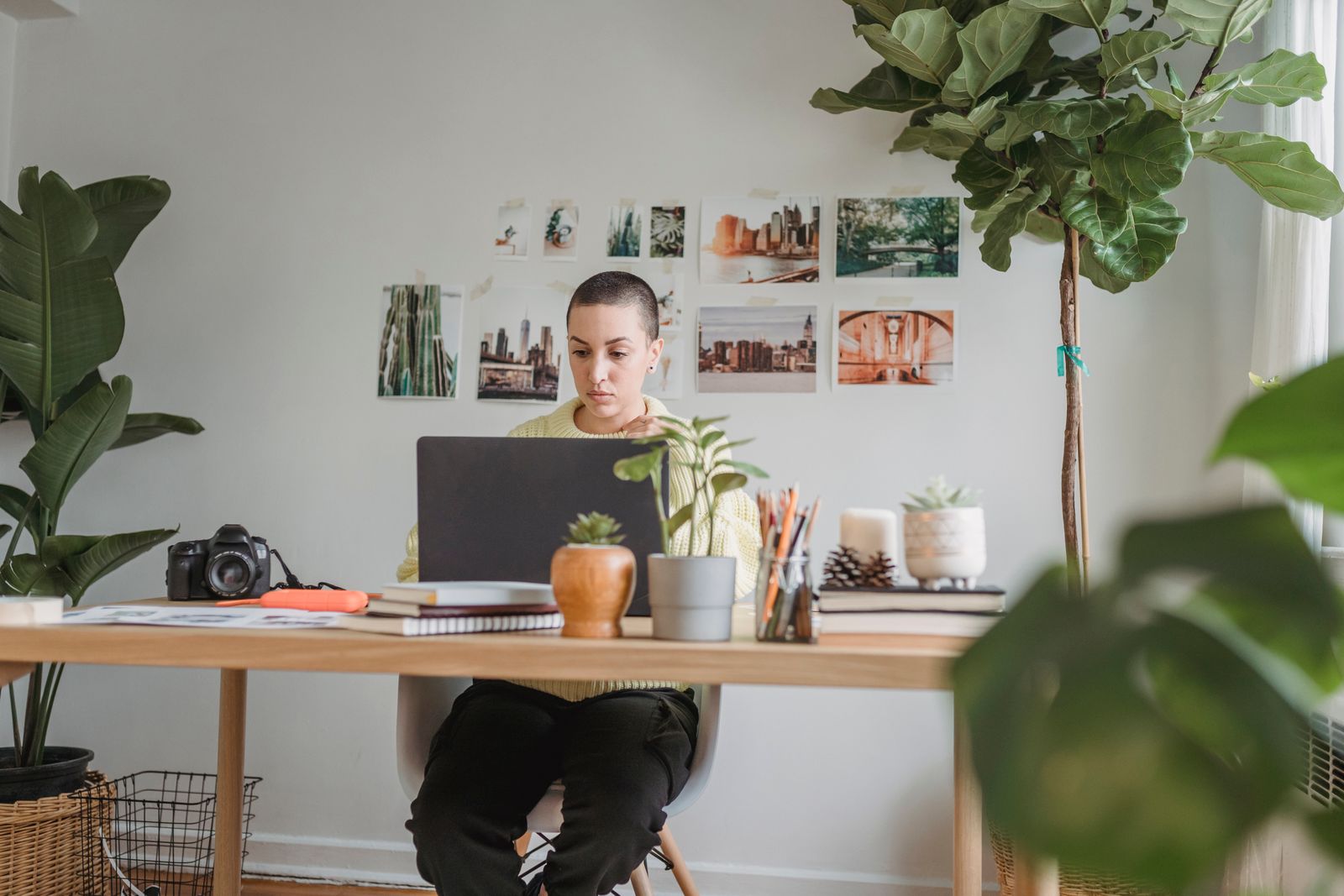 A photographer reviewing work on a laptop at a table