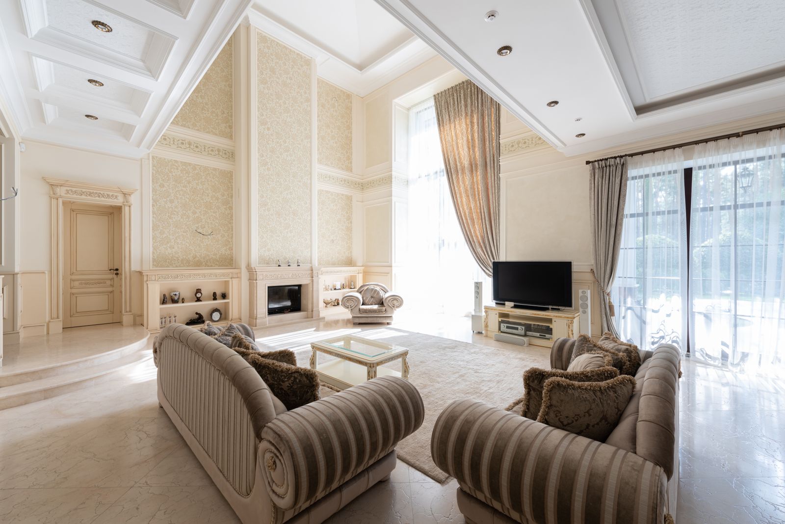 A living room with sofas beside windows and curtains
