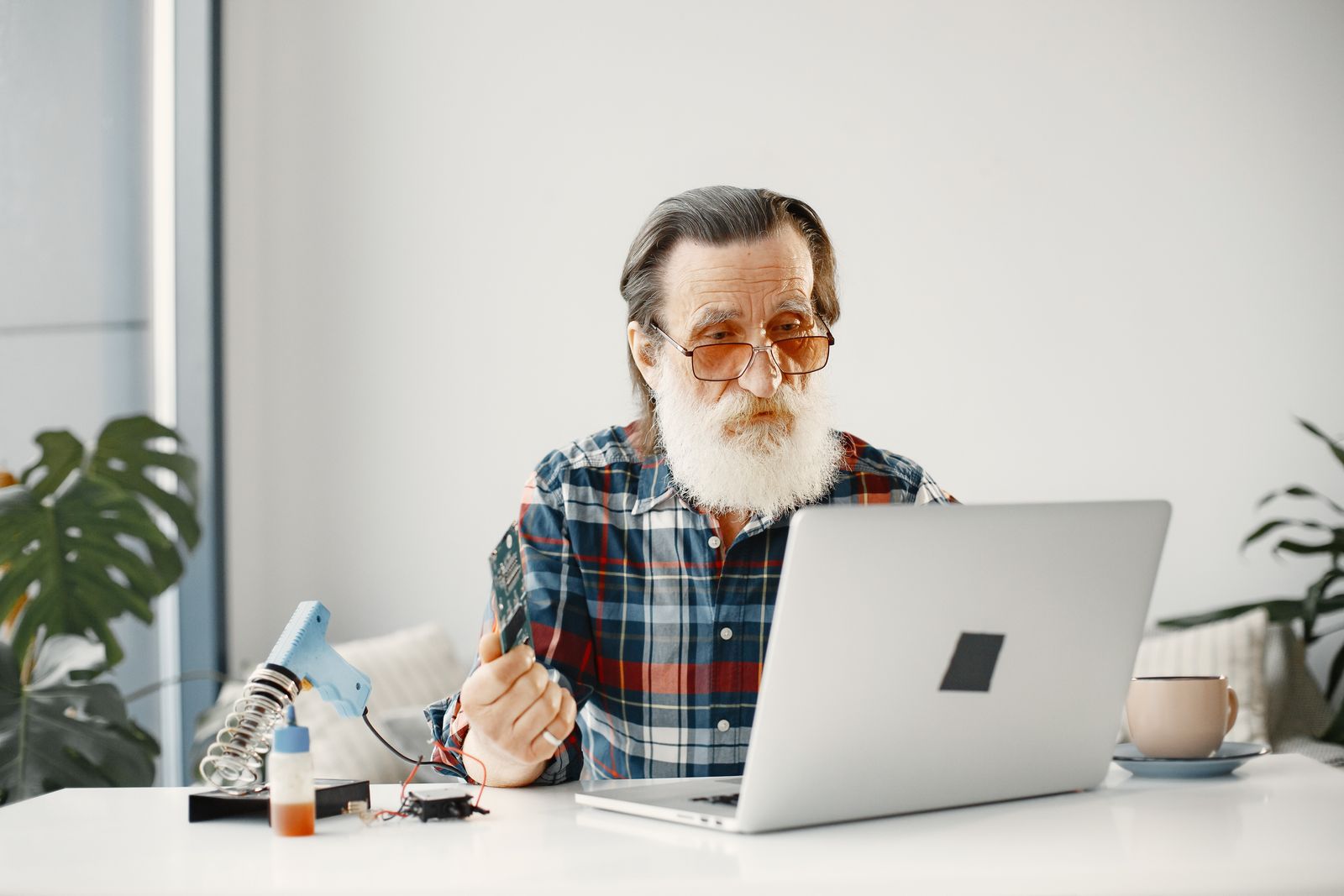 A person video calling from a desk with a laptop