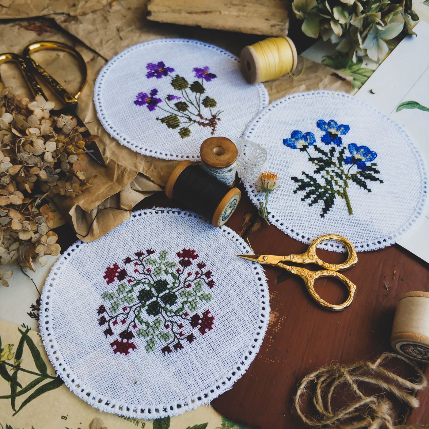 Finished embroidered textiles beside sewing supplies