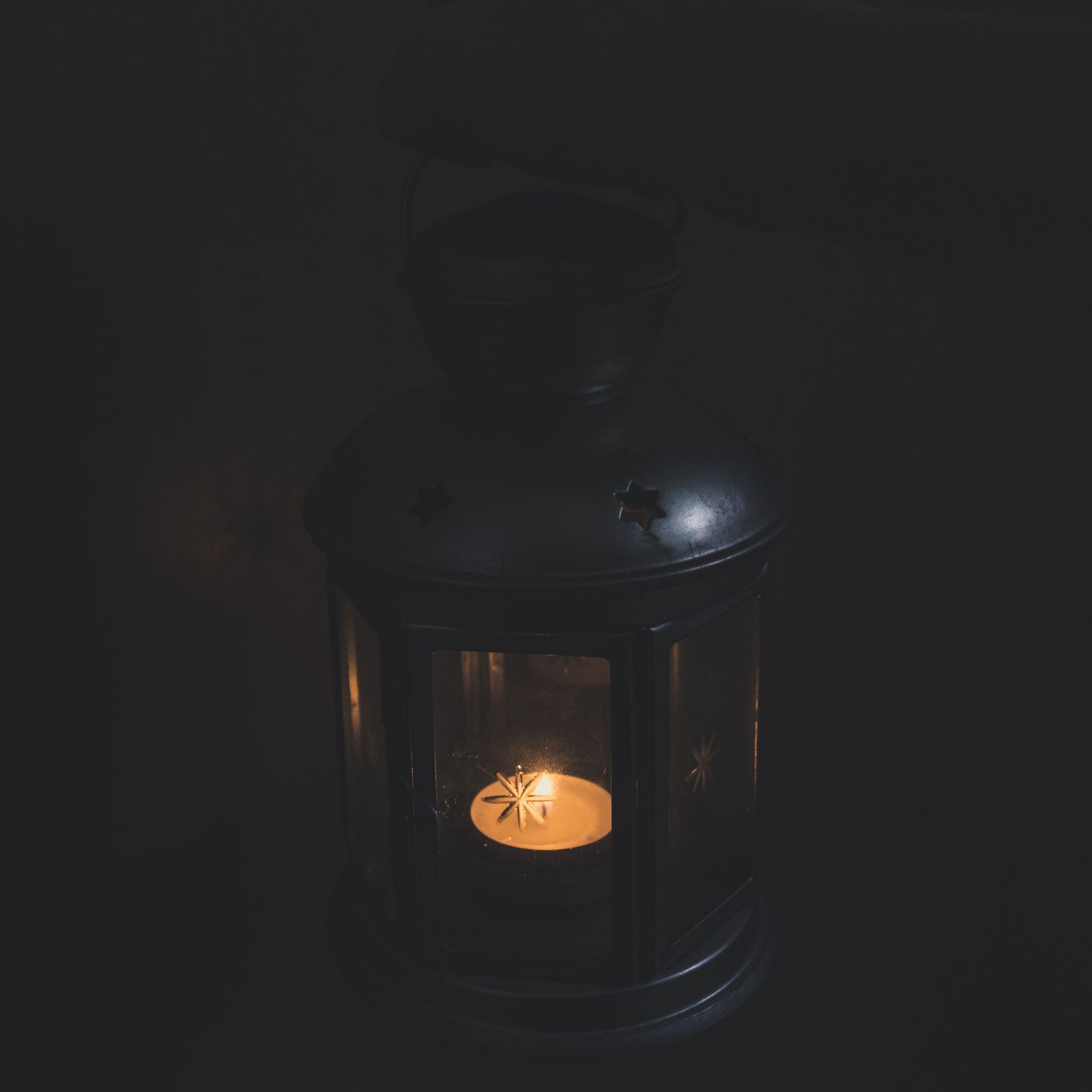 A lantern glowing in a dim room