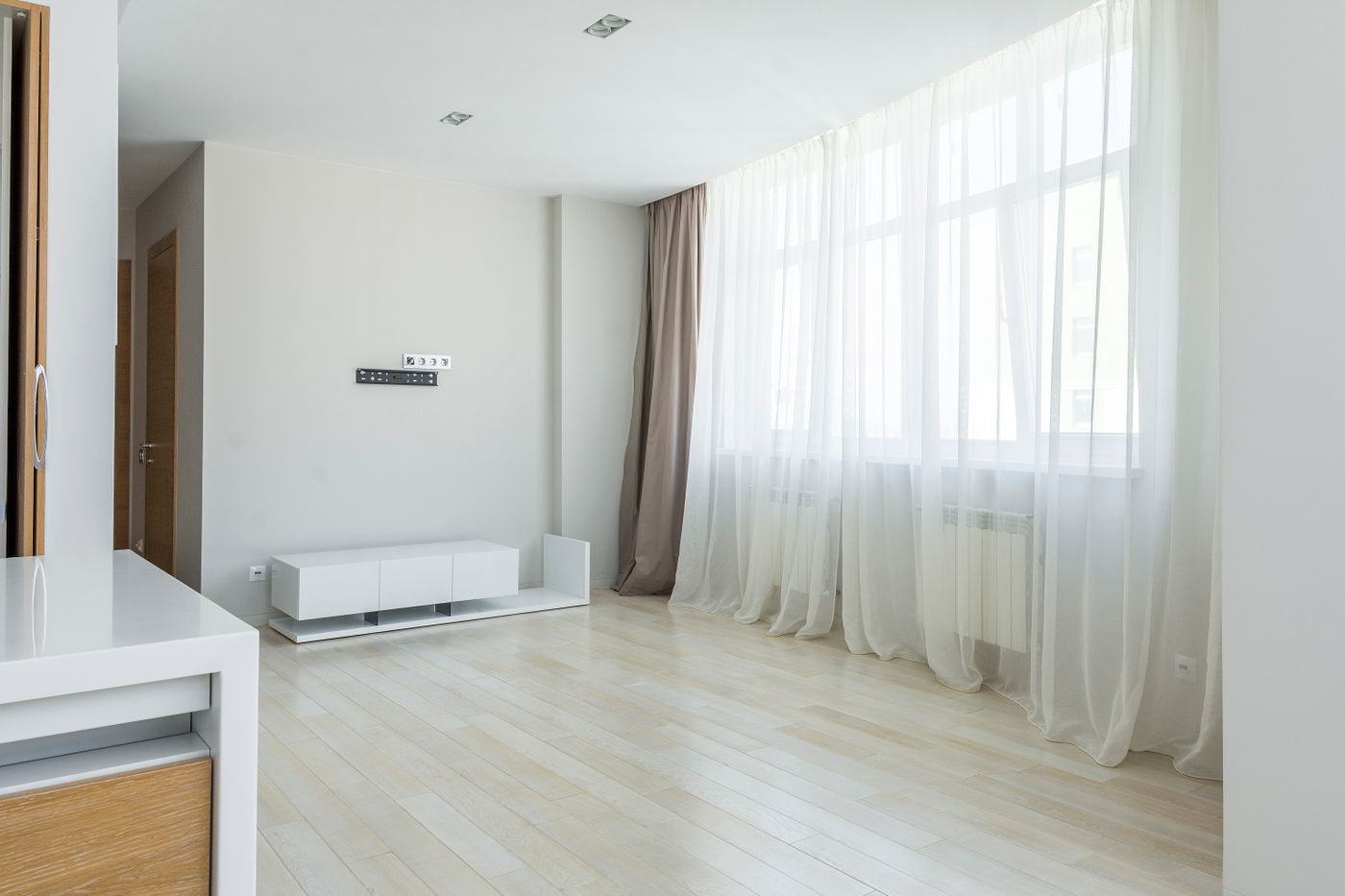 Open side panels and a sheer layer in an empty room