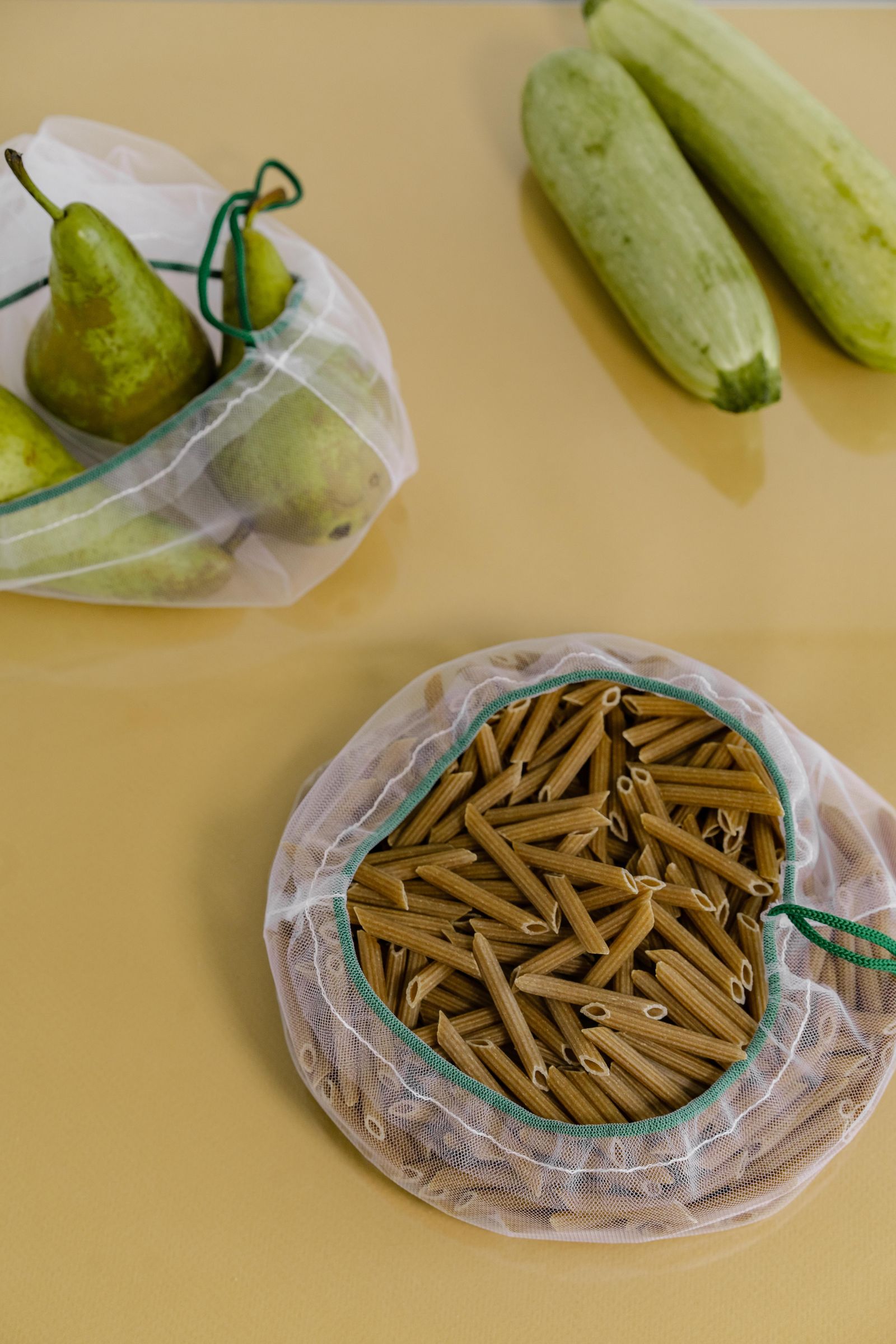 Reusable mesh bags containing produce and pasta