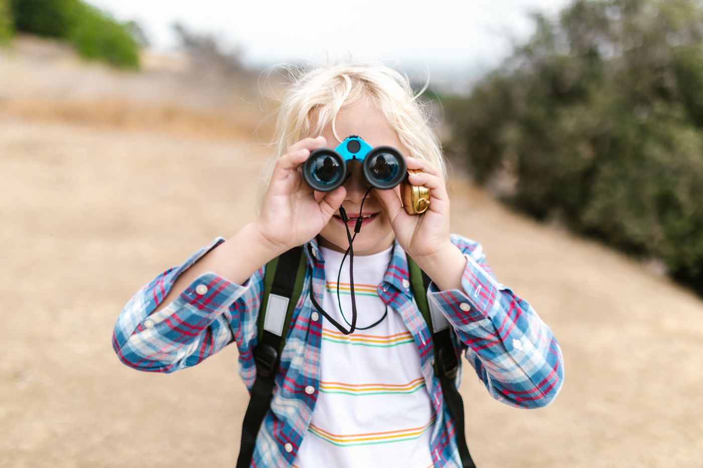 Child using binoculars outdoors