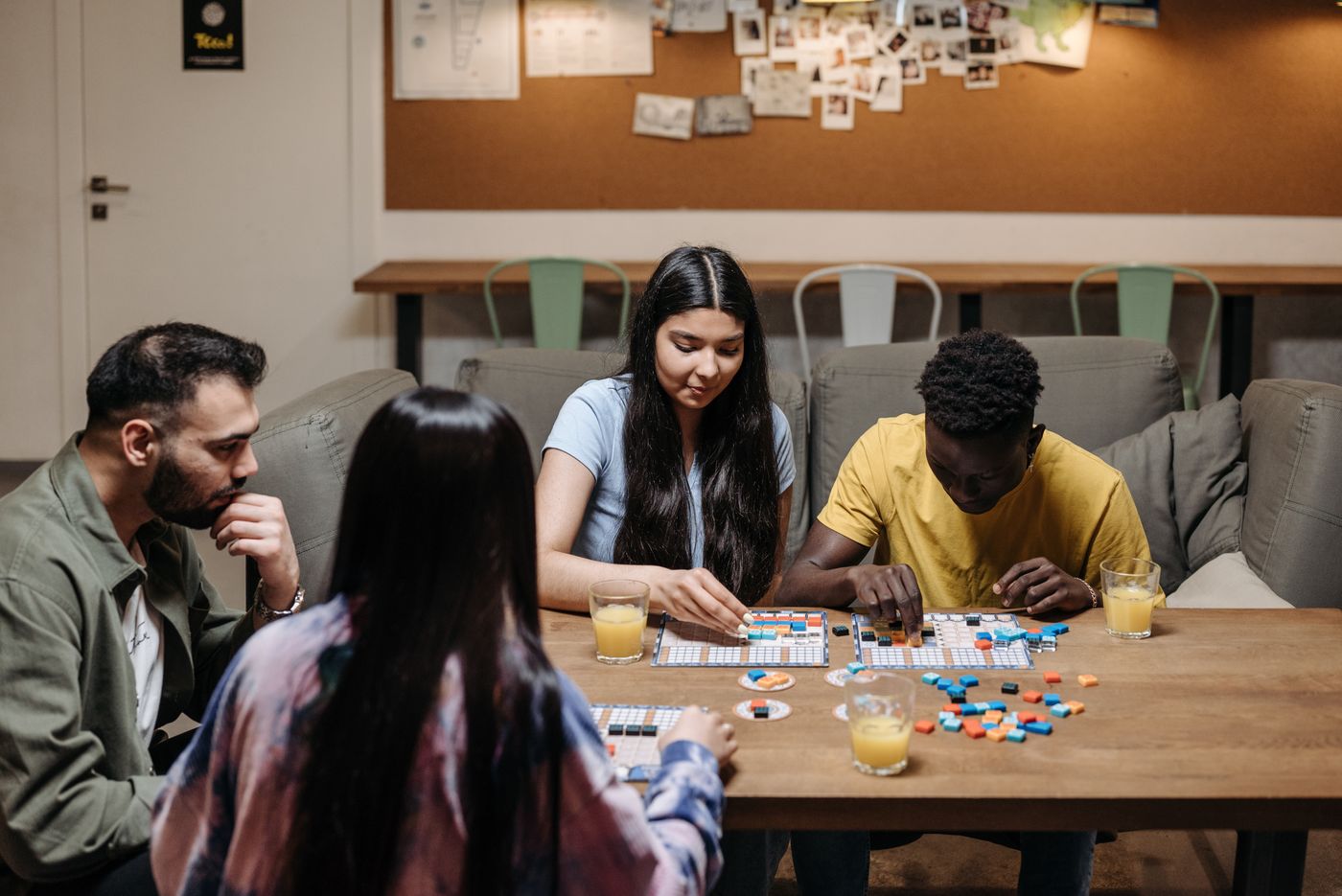 Adults gathered around a board game