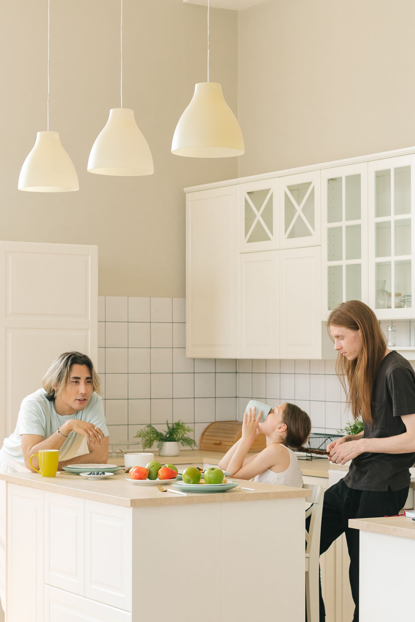 Adults and children around a kitchen eating area
