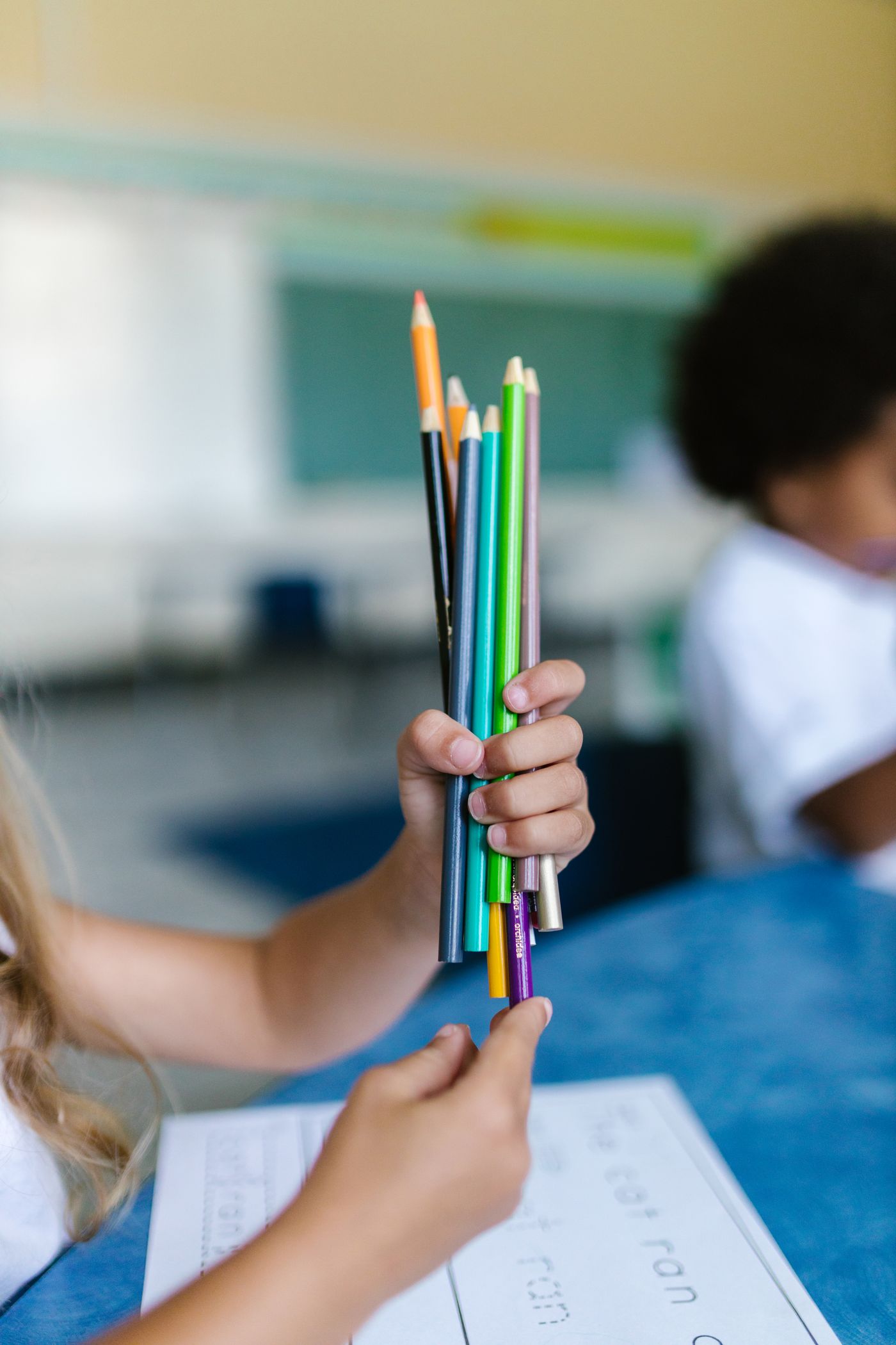 Hand holding a selection of colored pencils