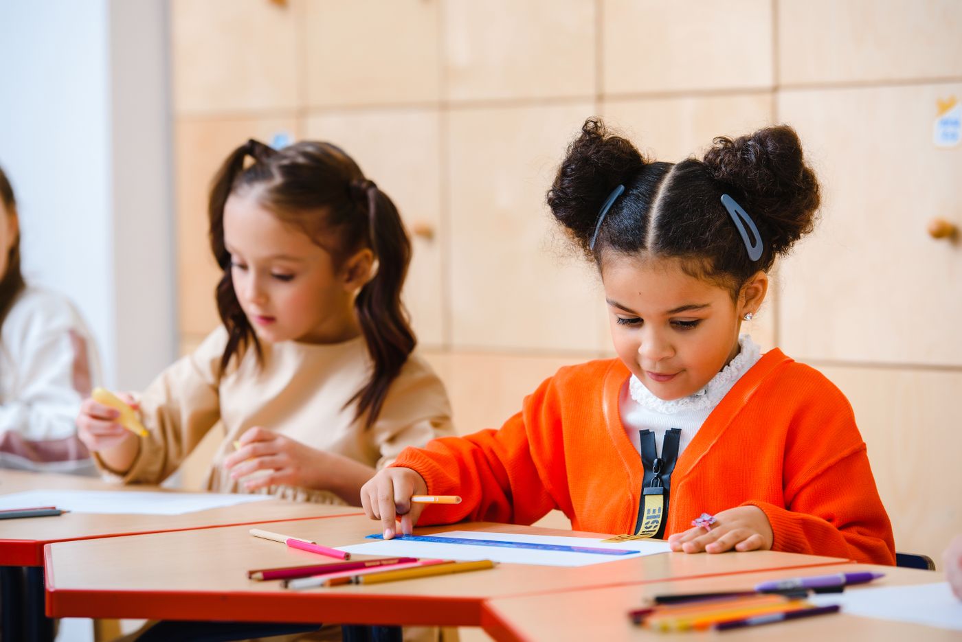 Children using pencils on their own drawing sheets