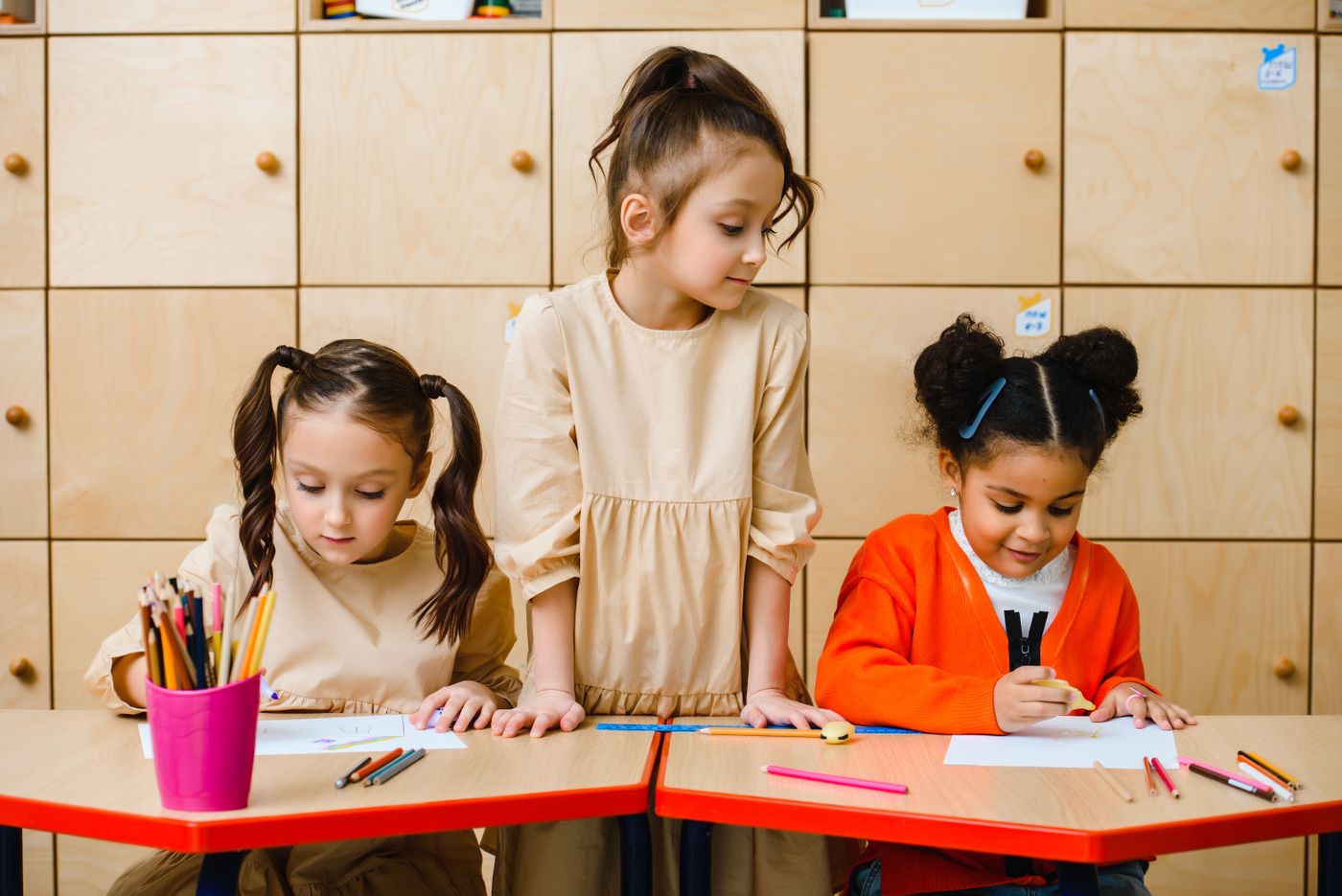 Children making separate drawings at adjoining tables