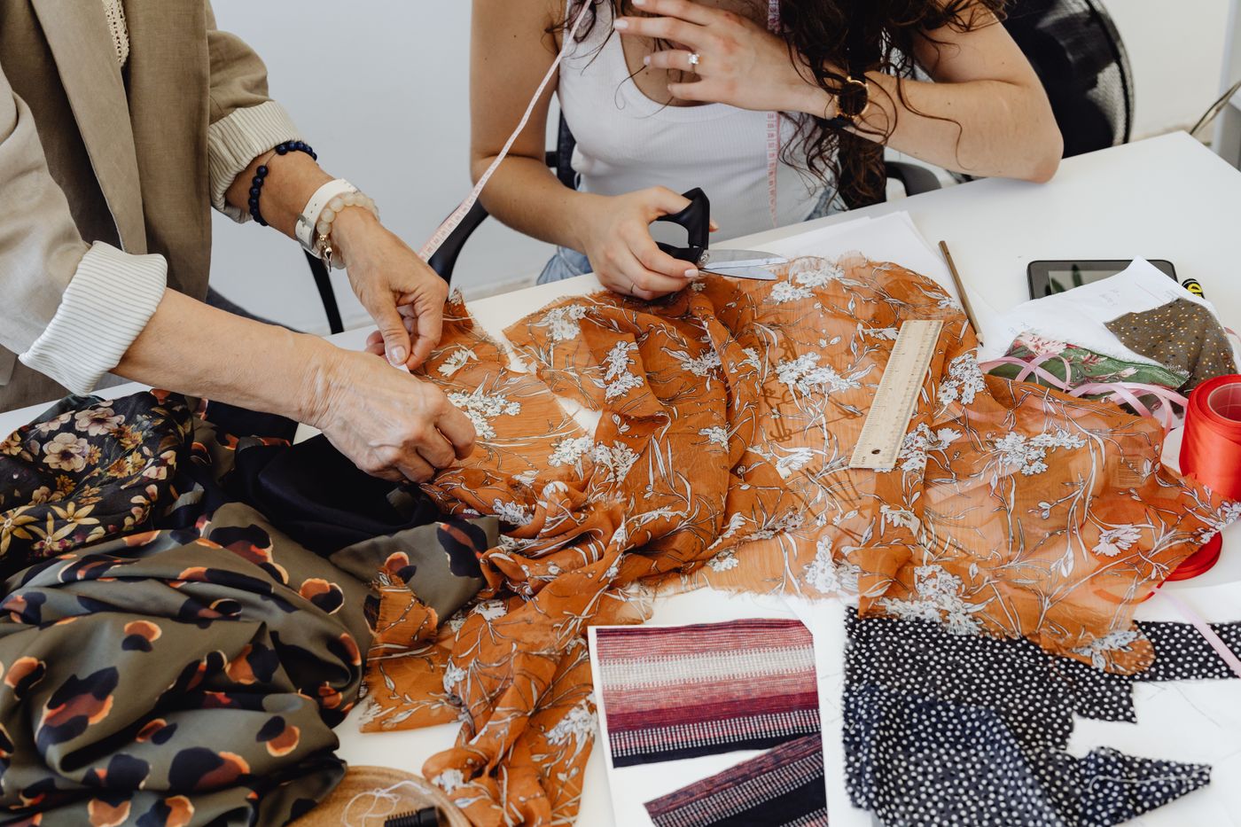 Shared sewing table with fabric remnants and tools