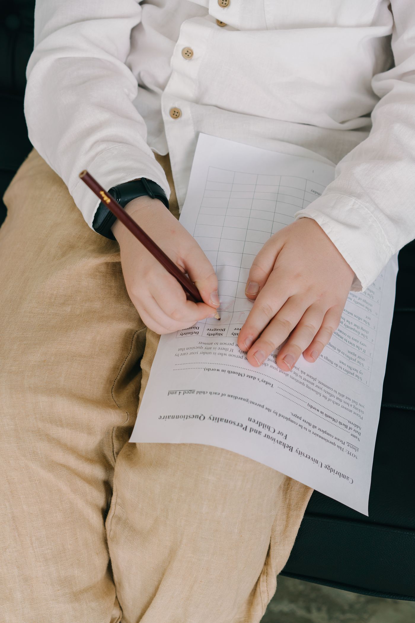 Child writing on a printed sheet; contribution-workflow context