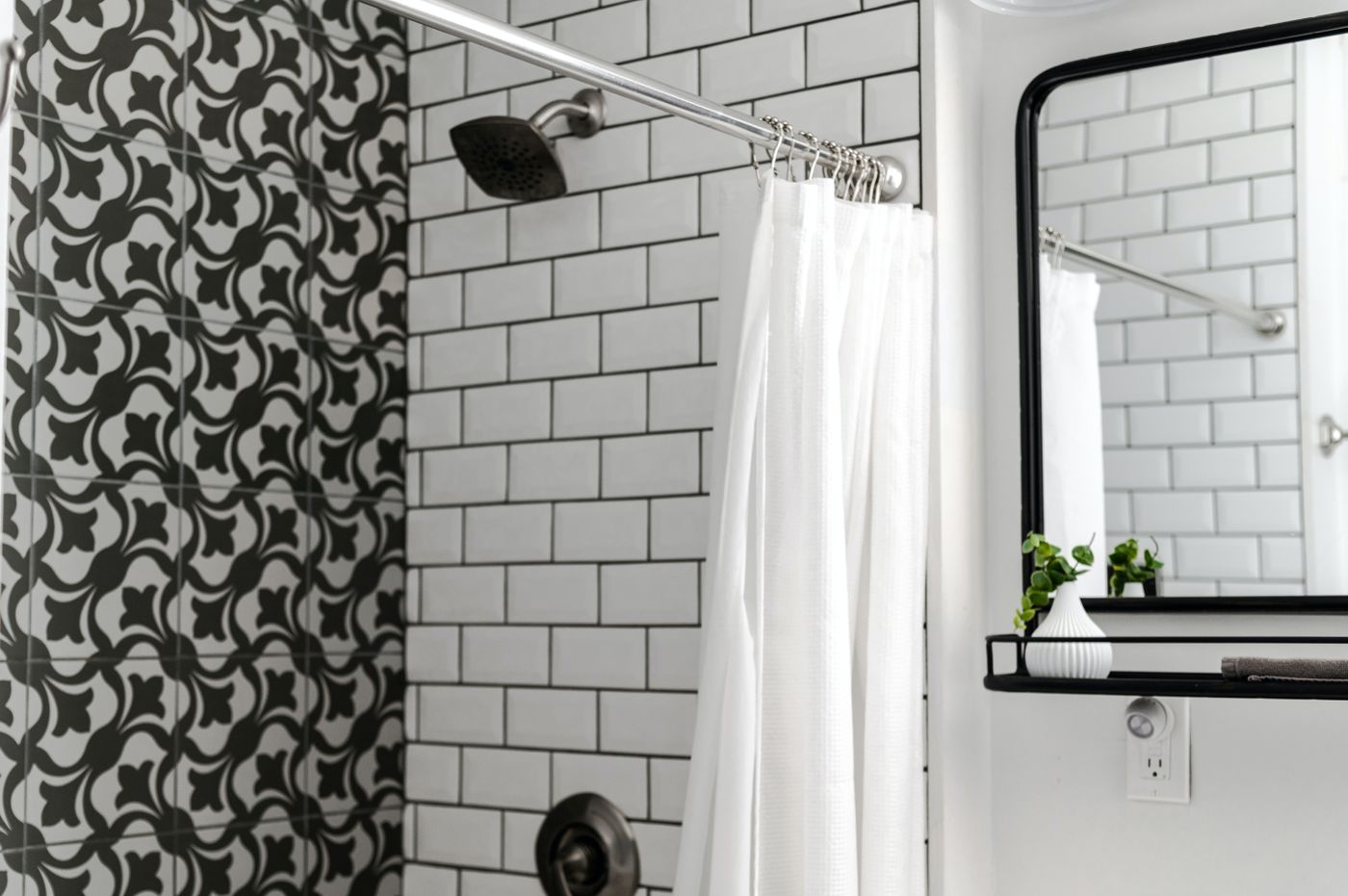 White shower curtain in a tiled bathroom